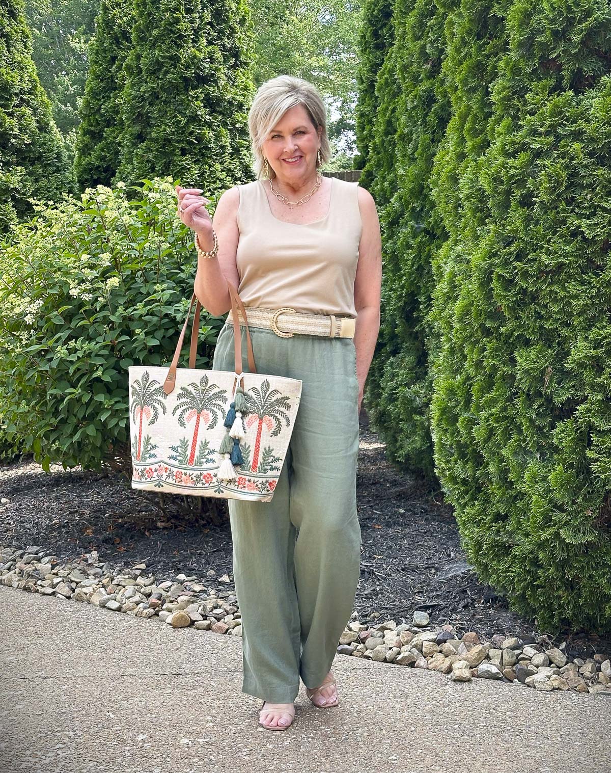 Over 50 Fashion Blogger, Tania Stephens is wearing olive pants, and carrying a Spartina 449 tote 5