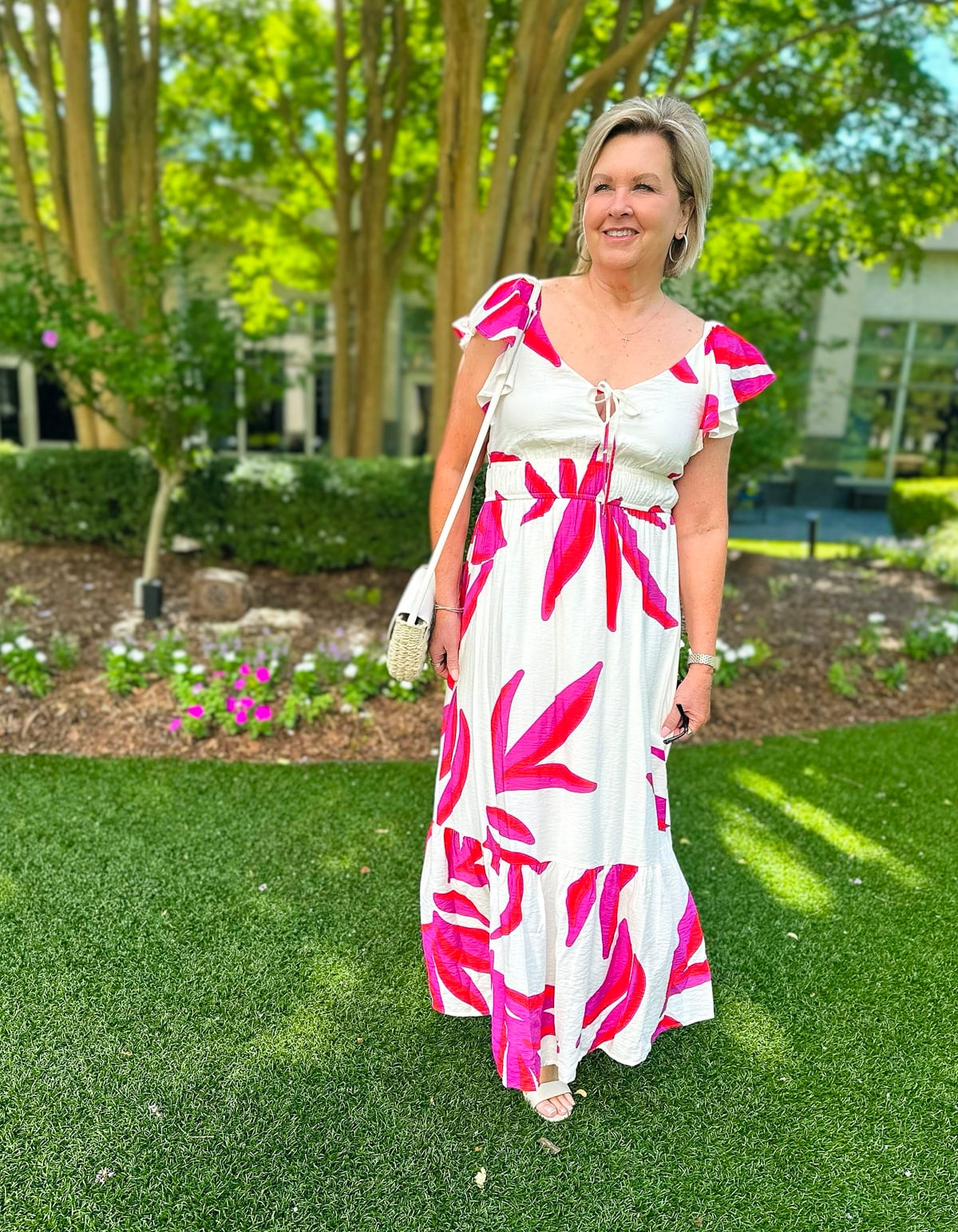 Over 50 fashion blogger, Tania Stephens is wearing a pink tropical sundress from Kohl's10