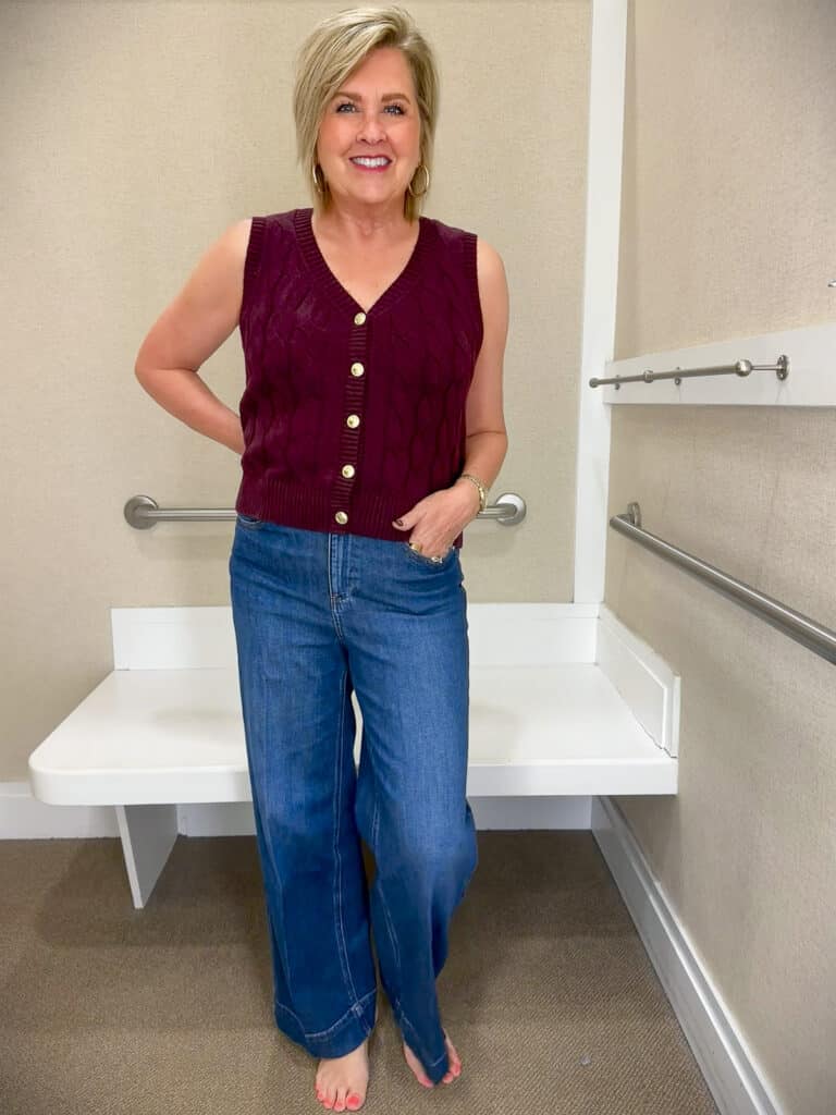 Tania Stephens is styling a burgundy sweater vest and wide leg jeans
