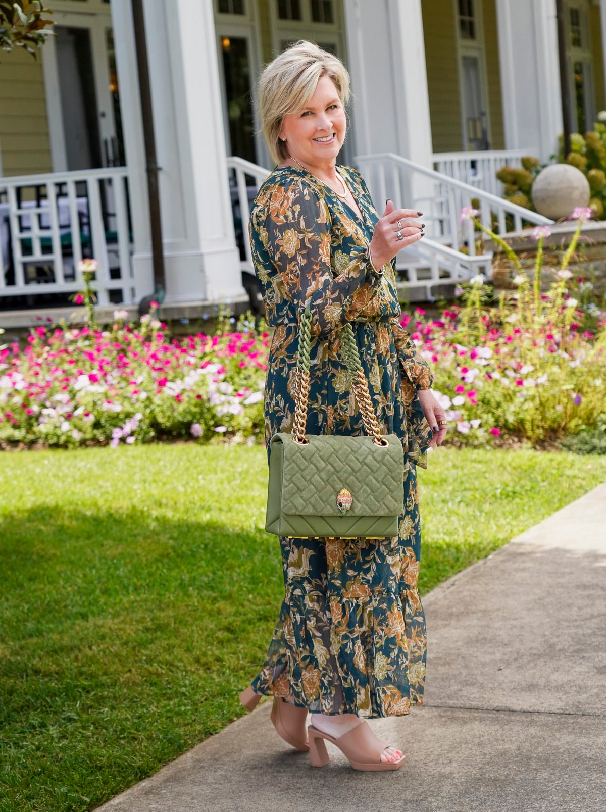Tania Stephens is wearing a deep green fall wedding guest dress from Nordstrom11