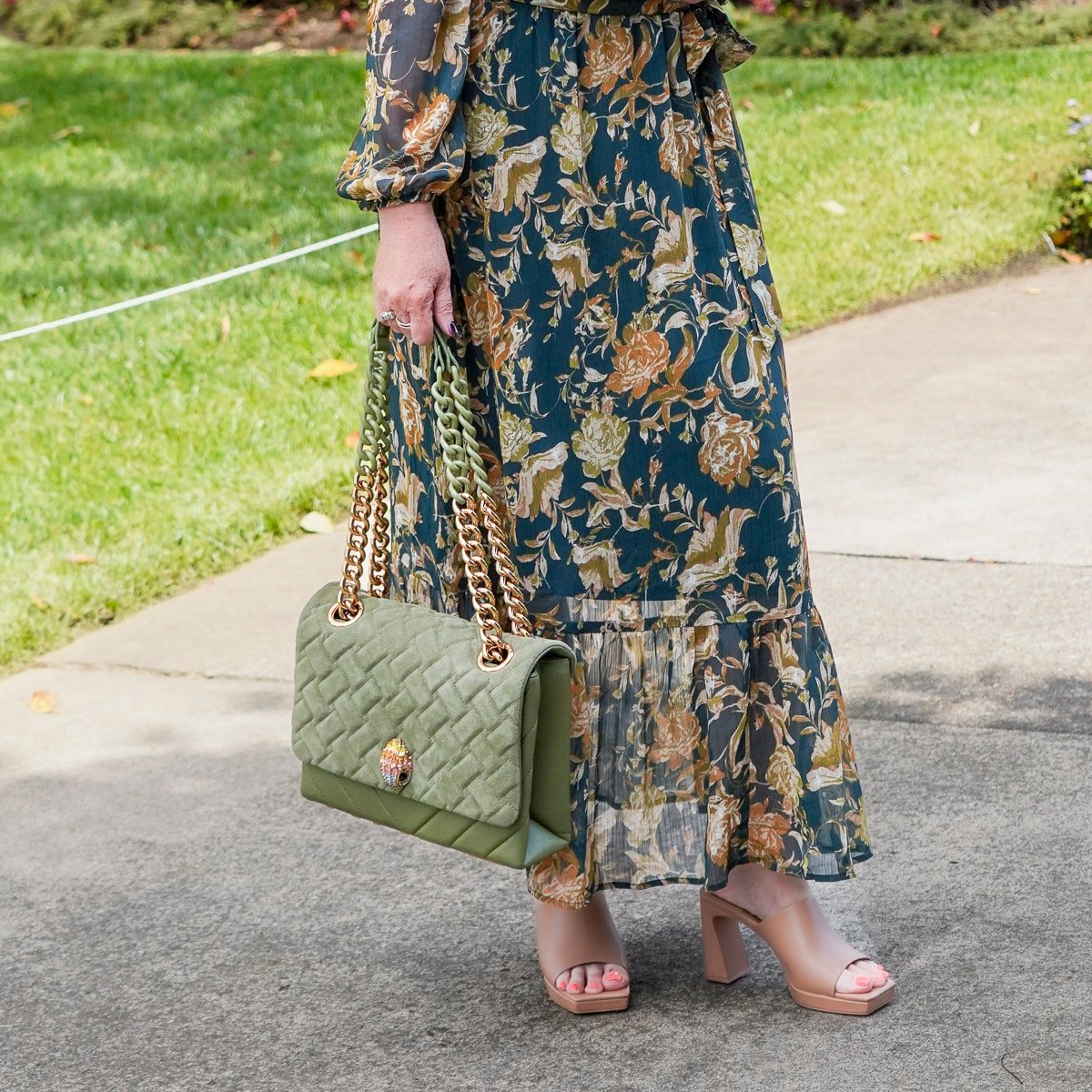 Tania Stephens is wearing a deep green fall wedding guest dress from Nordstrom12