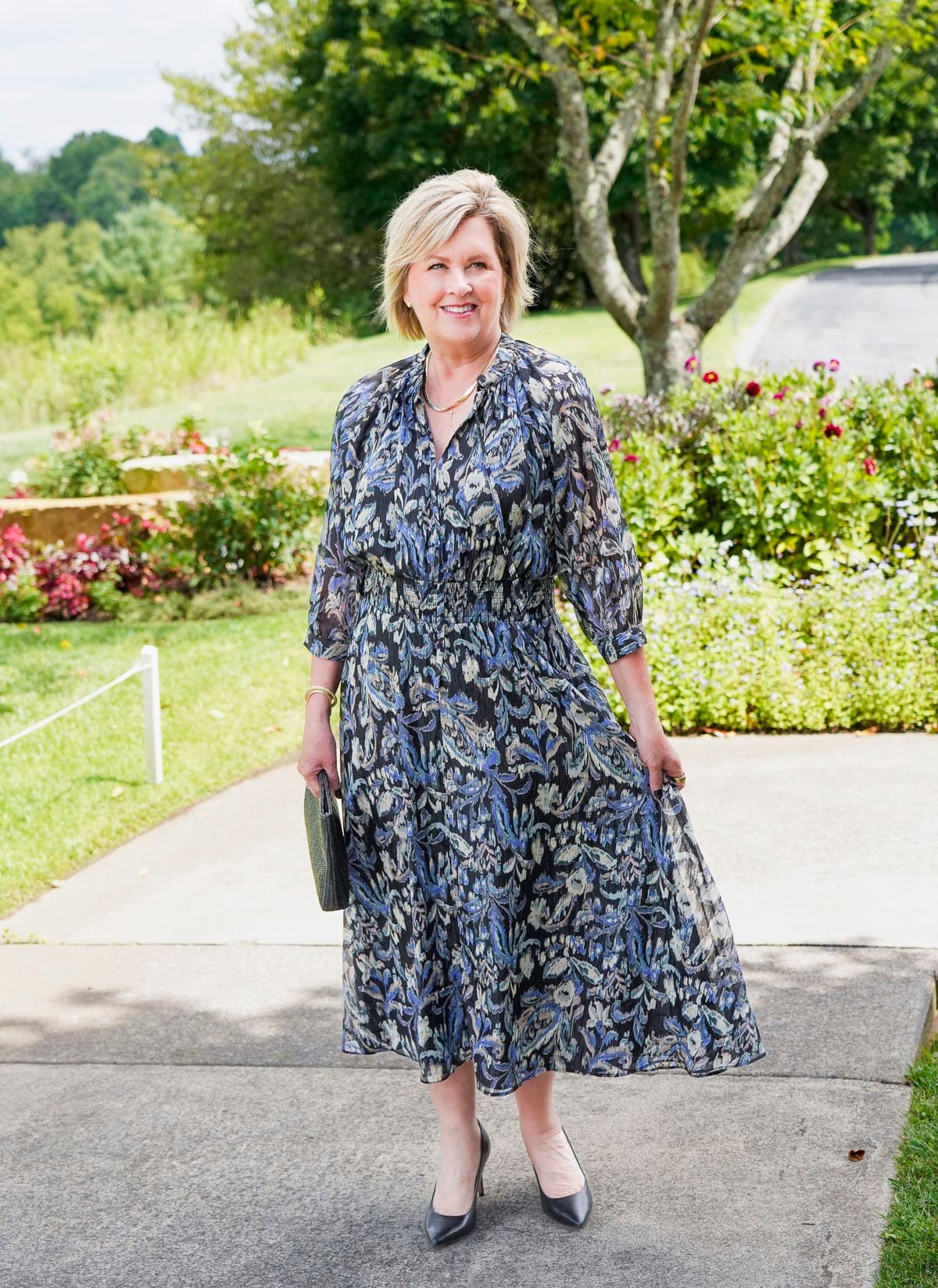 Tania Stephens is wearing a blue floral fall wedding guest dress from Nordstrom17