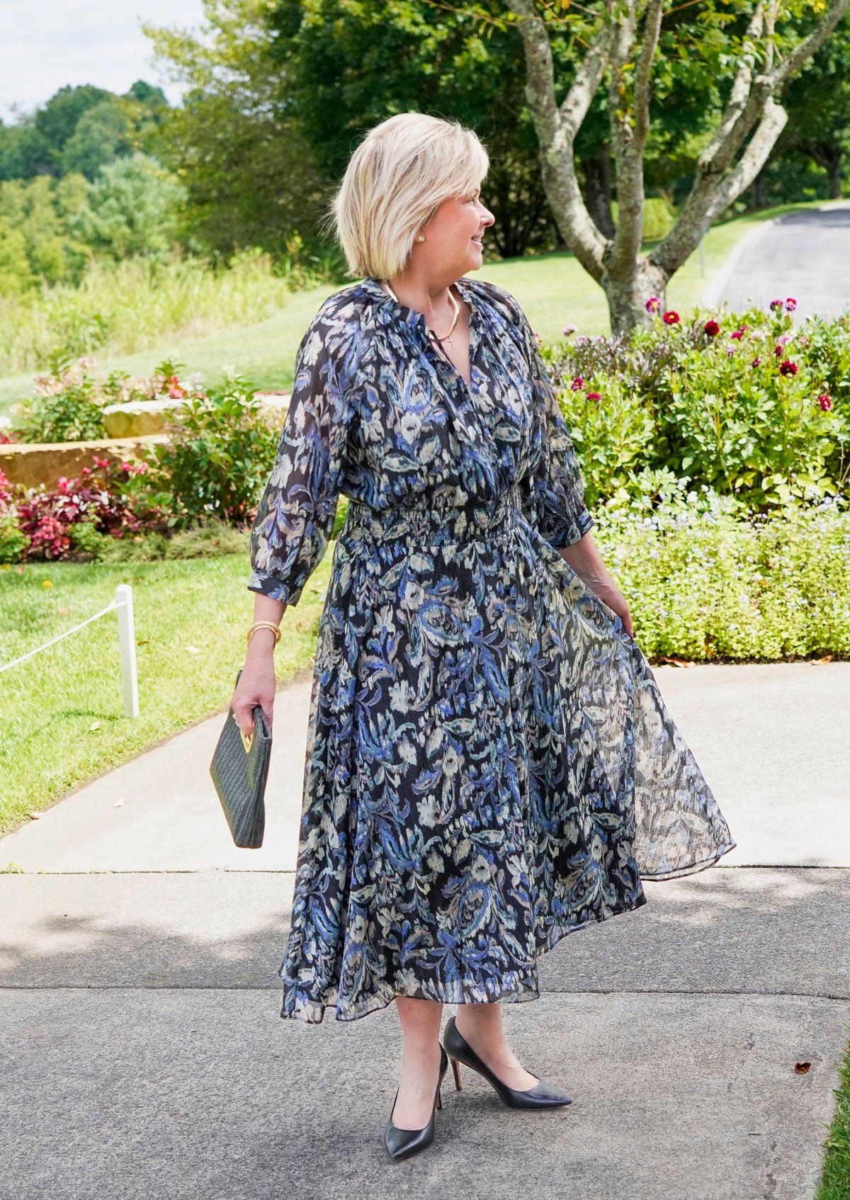 Tania Stephens is wearing a blue floral fall wedding guest dress from Nordstrom18