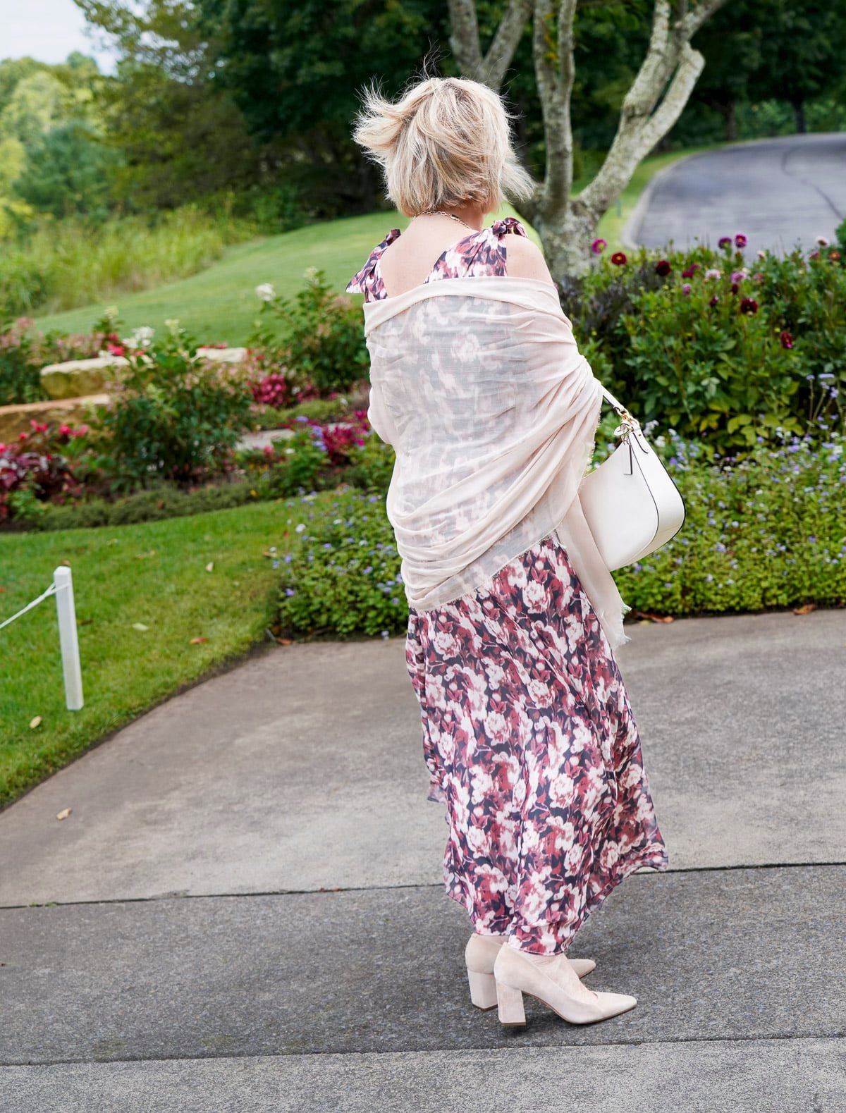 Tania Stephens is wearing a muted plum floral fall wedding guest dress from Nordstrom26