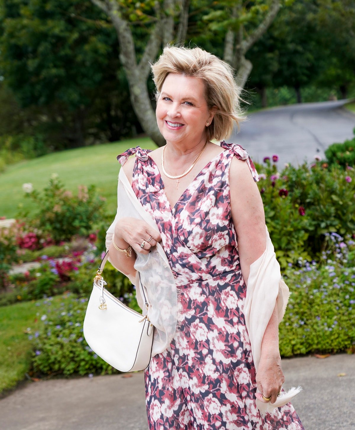 Tania Stephens is wearing a muted plum floral fall wedding guest dress from Nordstrom28