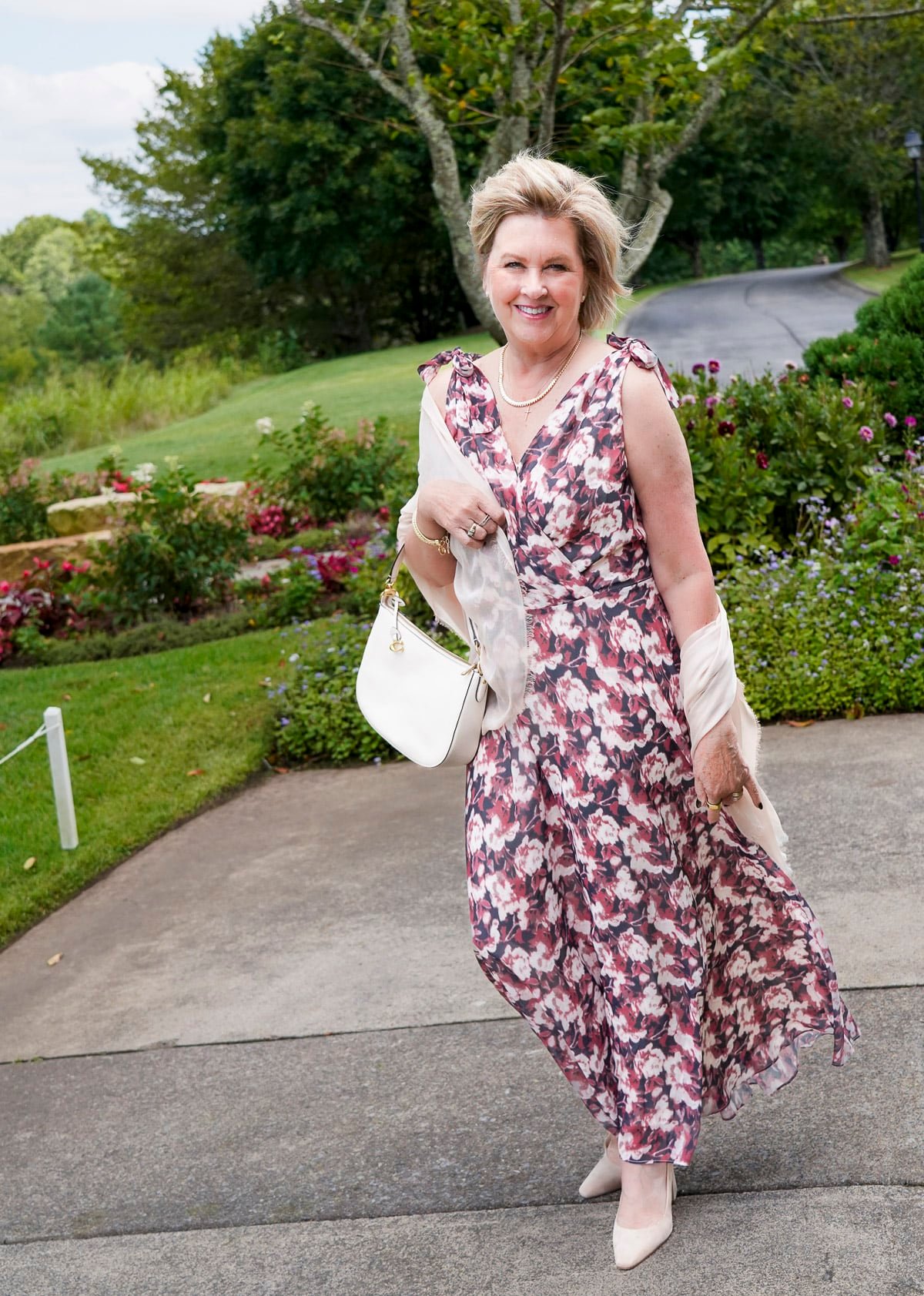 Tania Stephens is wearing a muted plum floral fall wedding guest dress from Nordstrom29