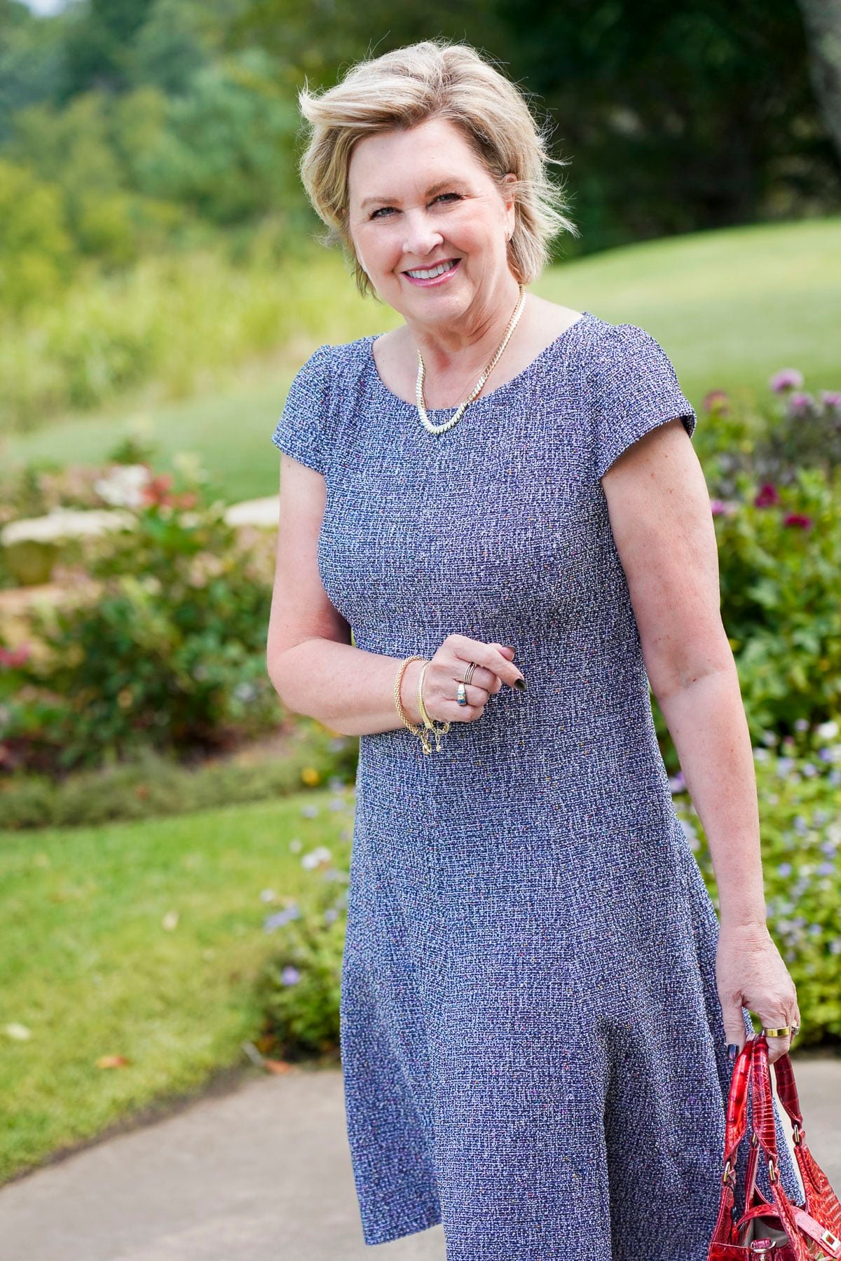 Tania Stephens is wearing a blue tweed fit and flare floral fall wedding guest dress from Nordstrom39