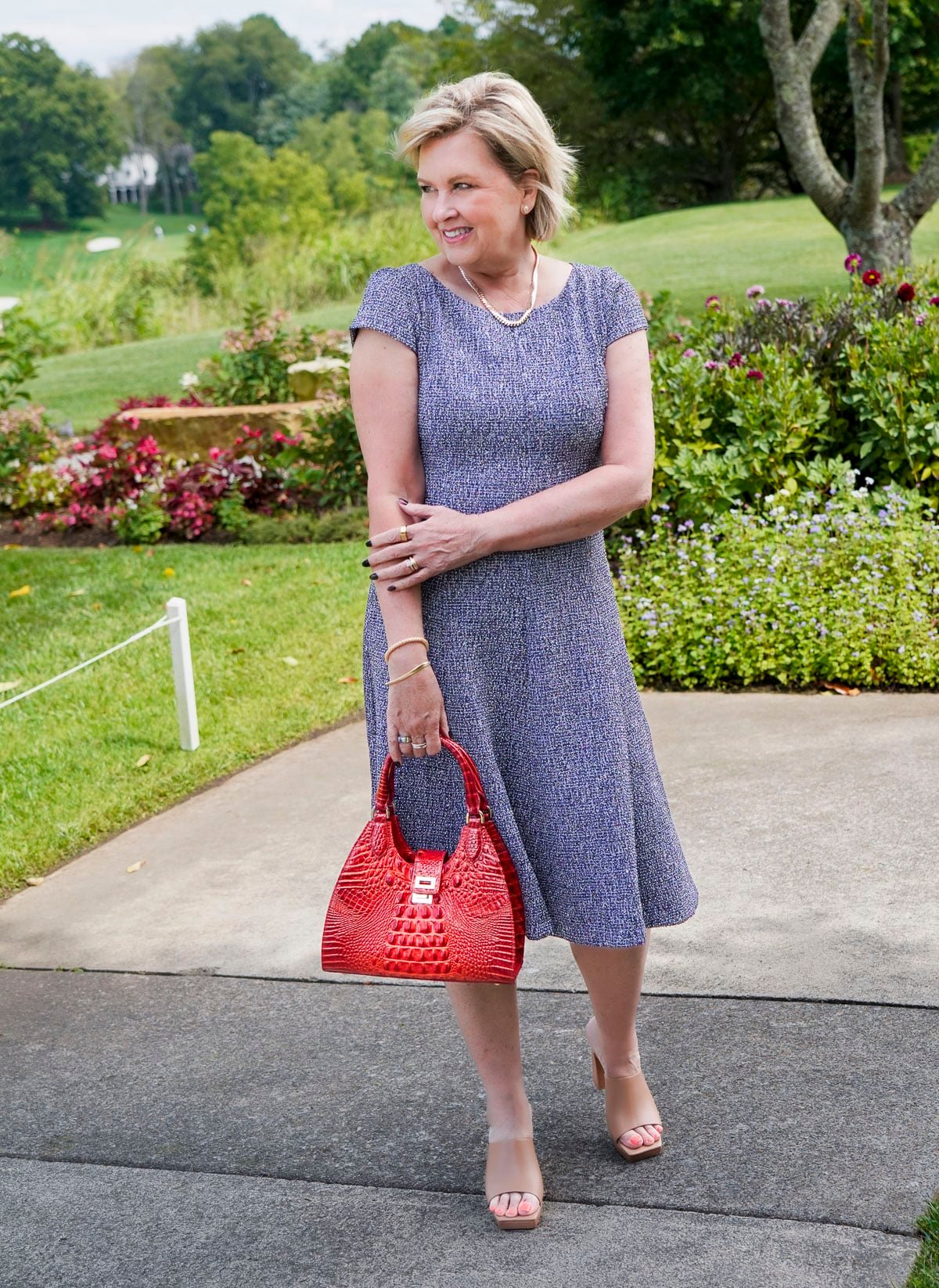 Tania Stephens is wearing a blue tweed fit and flare floral fall wedding guest dress from Nordstrom40