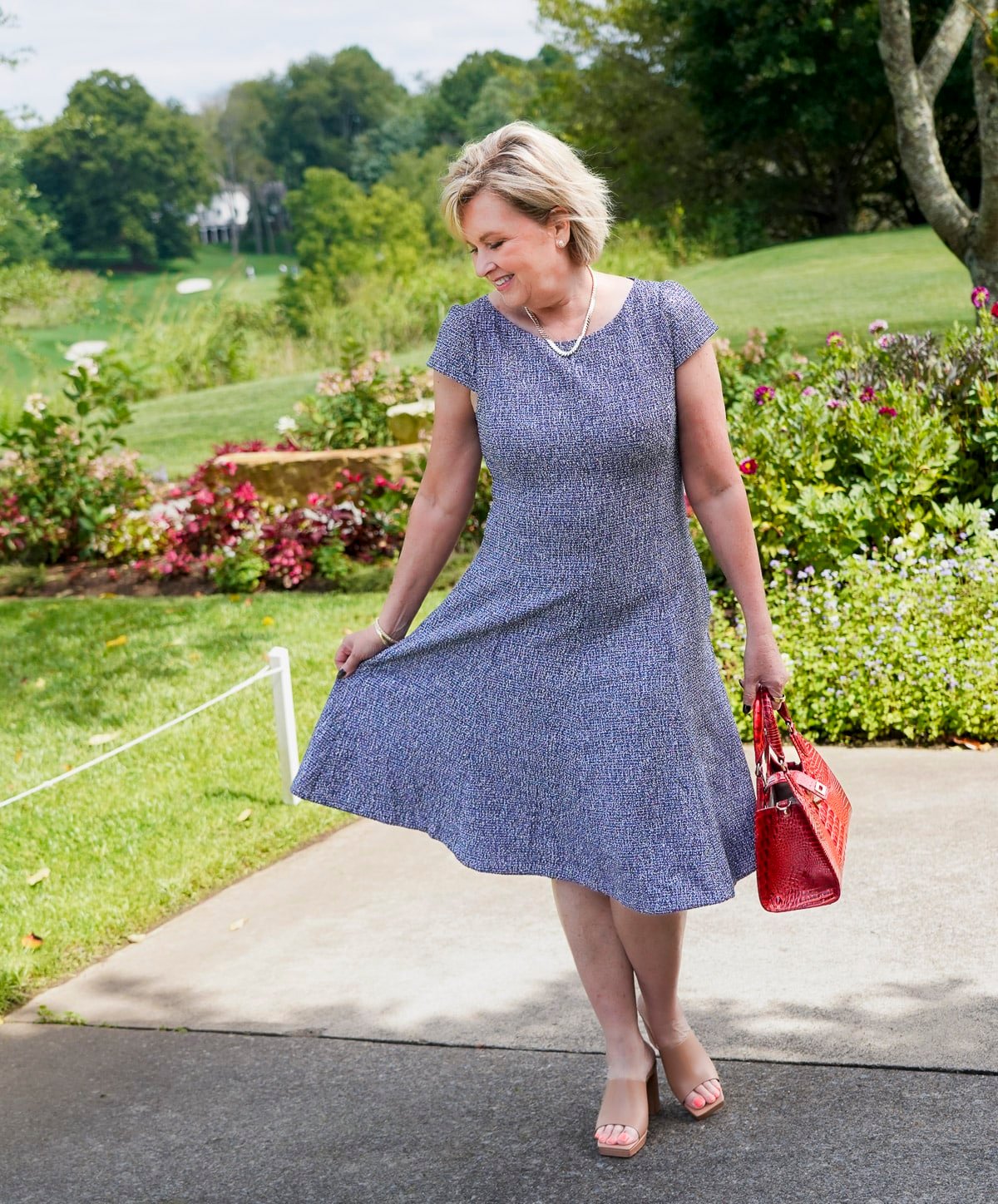 Tania Stephens is wearing a blue tweed fit and flare floral fall wedding guest dress from Nordstrom44