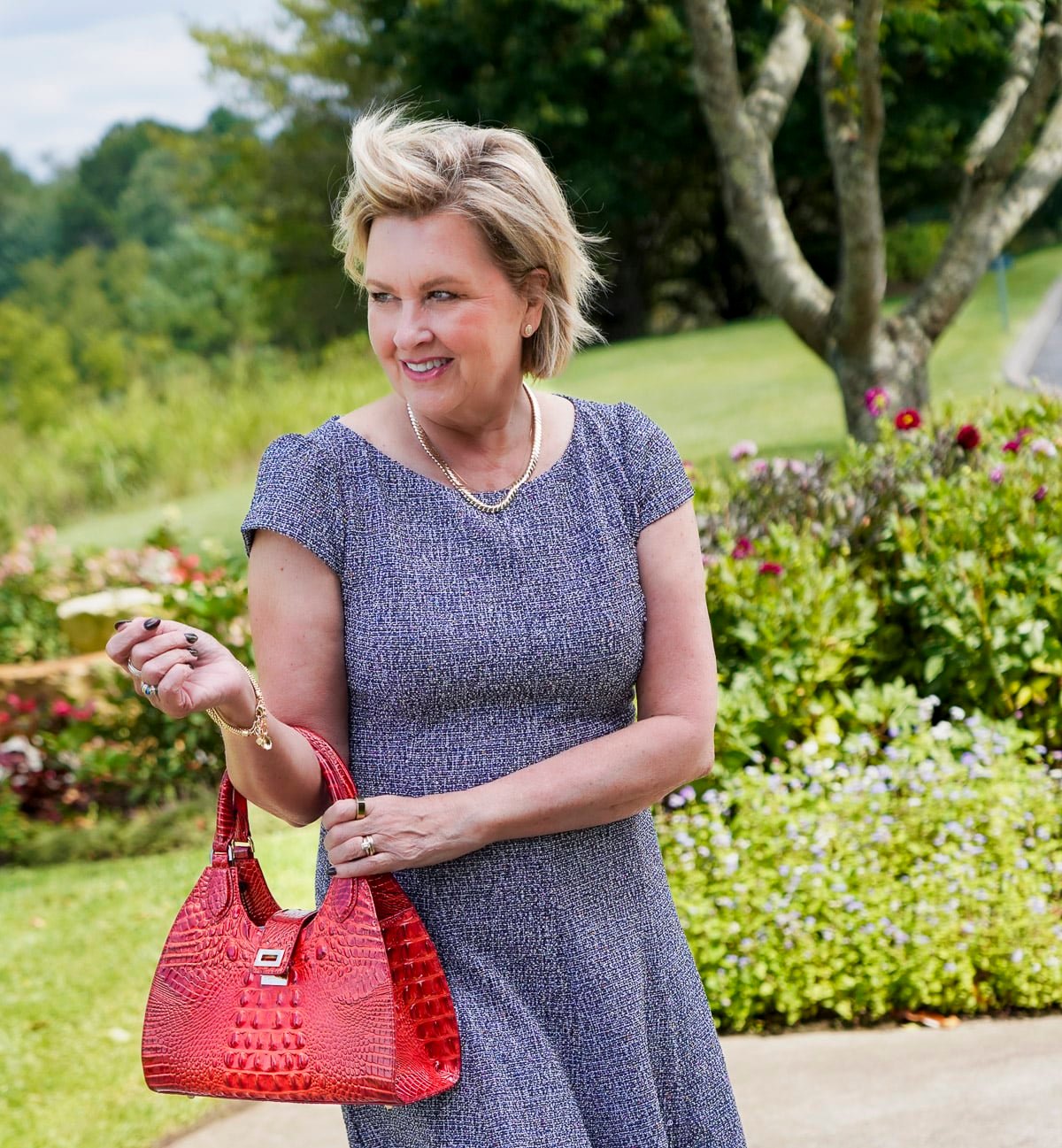 Tania Stephens is wearing a blue tweed fit and flare floral fall wedding guest dress from Nordstrom46