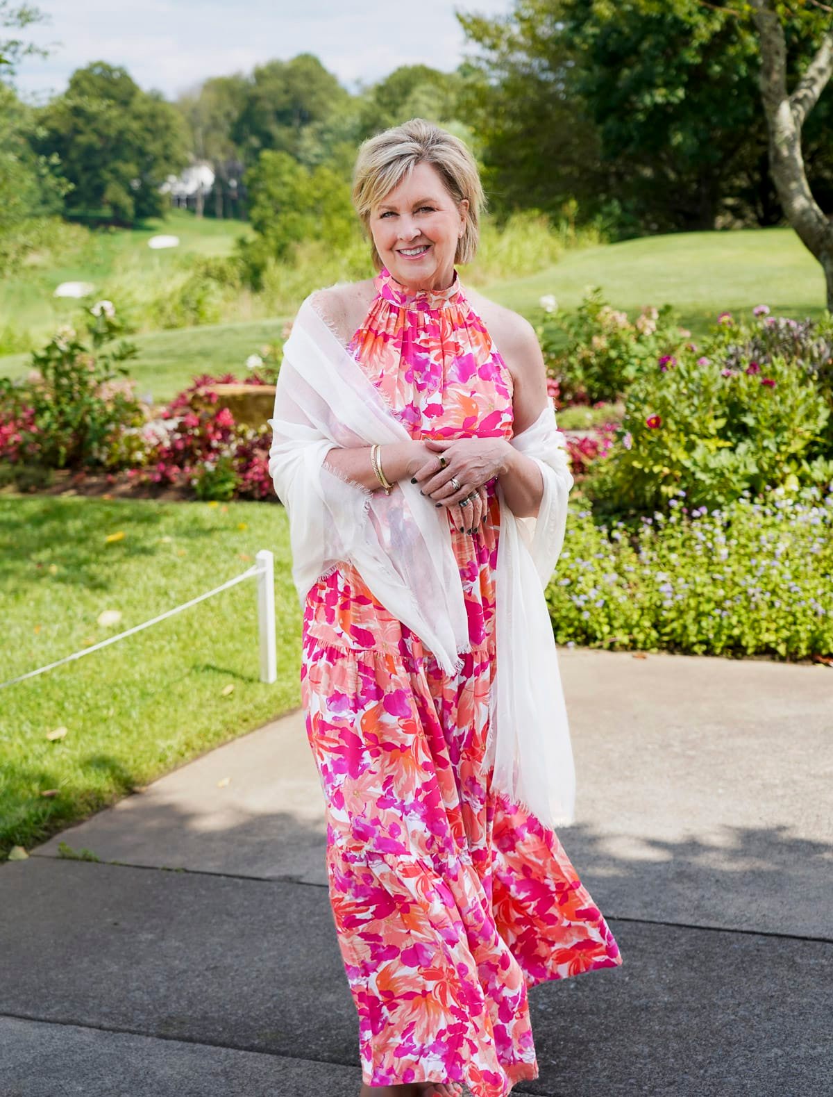 Tania Stephens is wearing a red & pink halter floral fall wedding guest dress from Nordstrom48