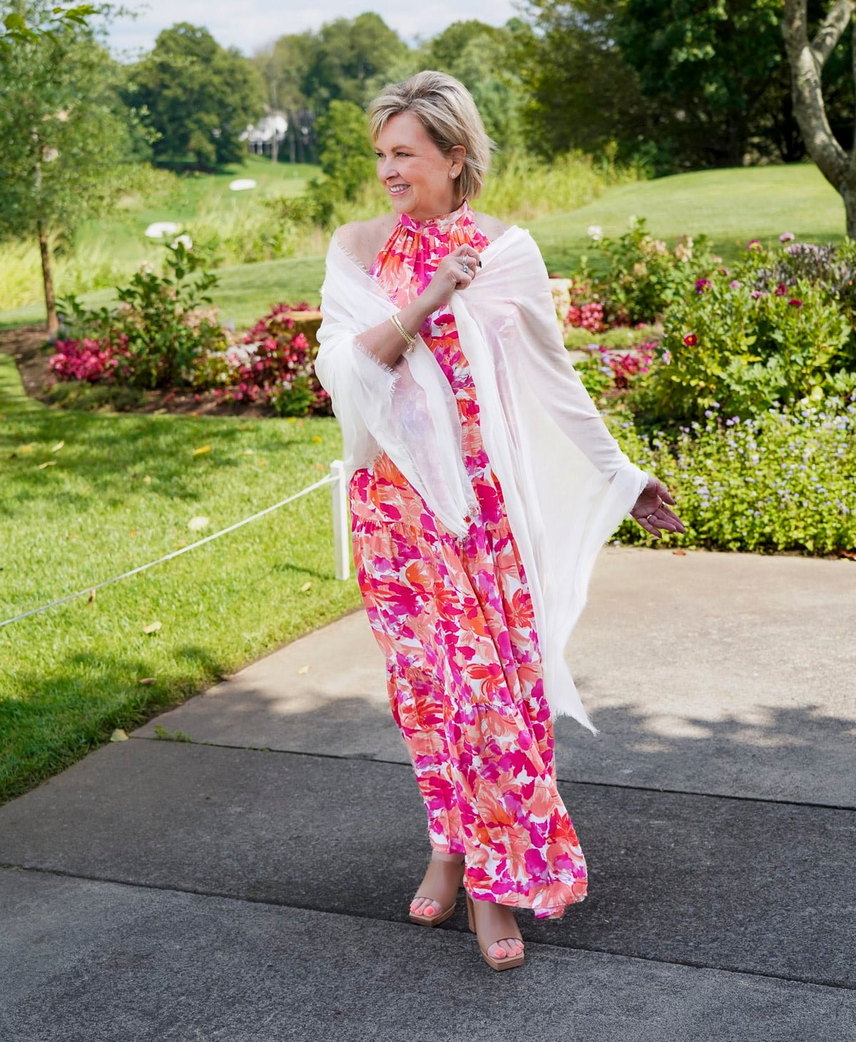 Tania Stephens is wearing a red & pink halter floral fall wedding guest dress from Nordstrom49
