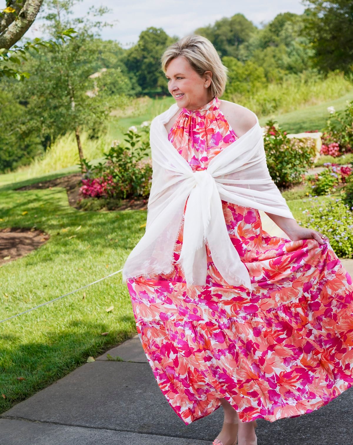 Tania Stephens is wearing a red & pink halter floral fall wedding guest dress from Nordstrom60