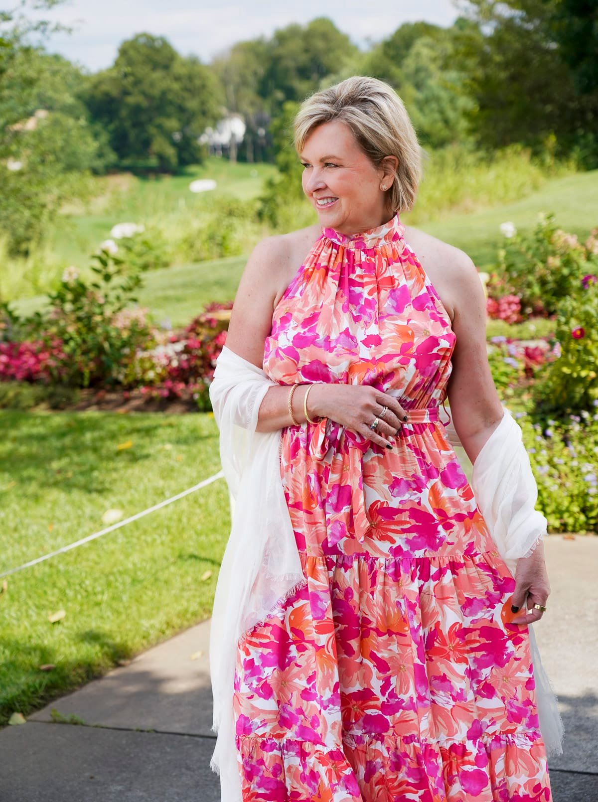 Tania Stephens is wearing a red & pink halter floral fall wedding guest dress from Nordstrom62