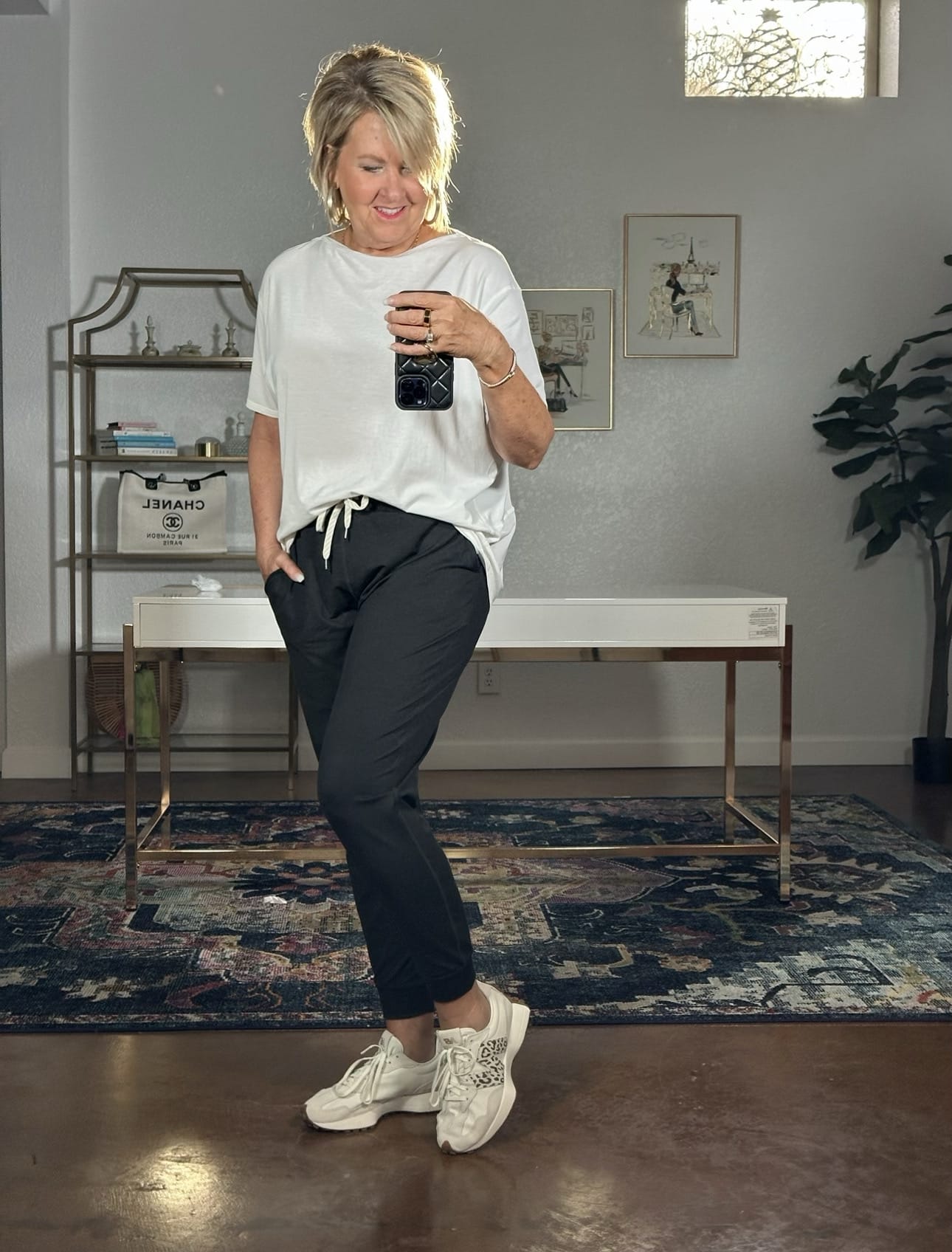 Tania Stephens is wearing black joggers and New Balance 327 sneakers