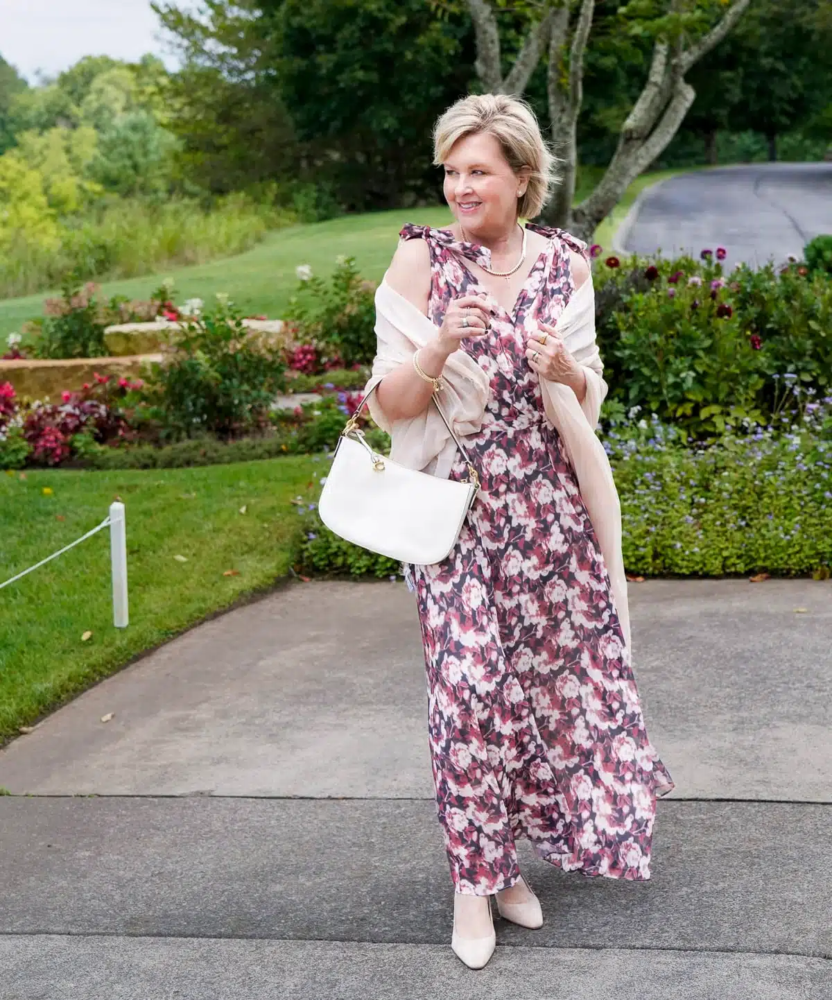Fashion Blogger, Tania Stephens is styling fall wedding dresses for women over 50 - floral tie shoulders
