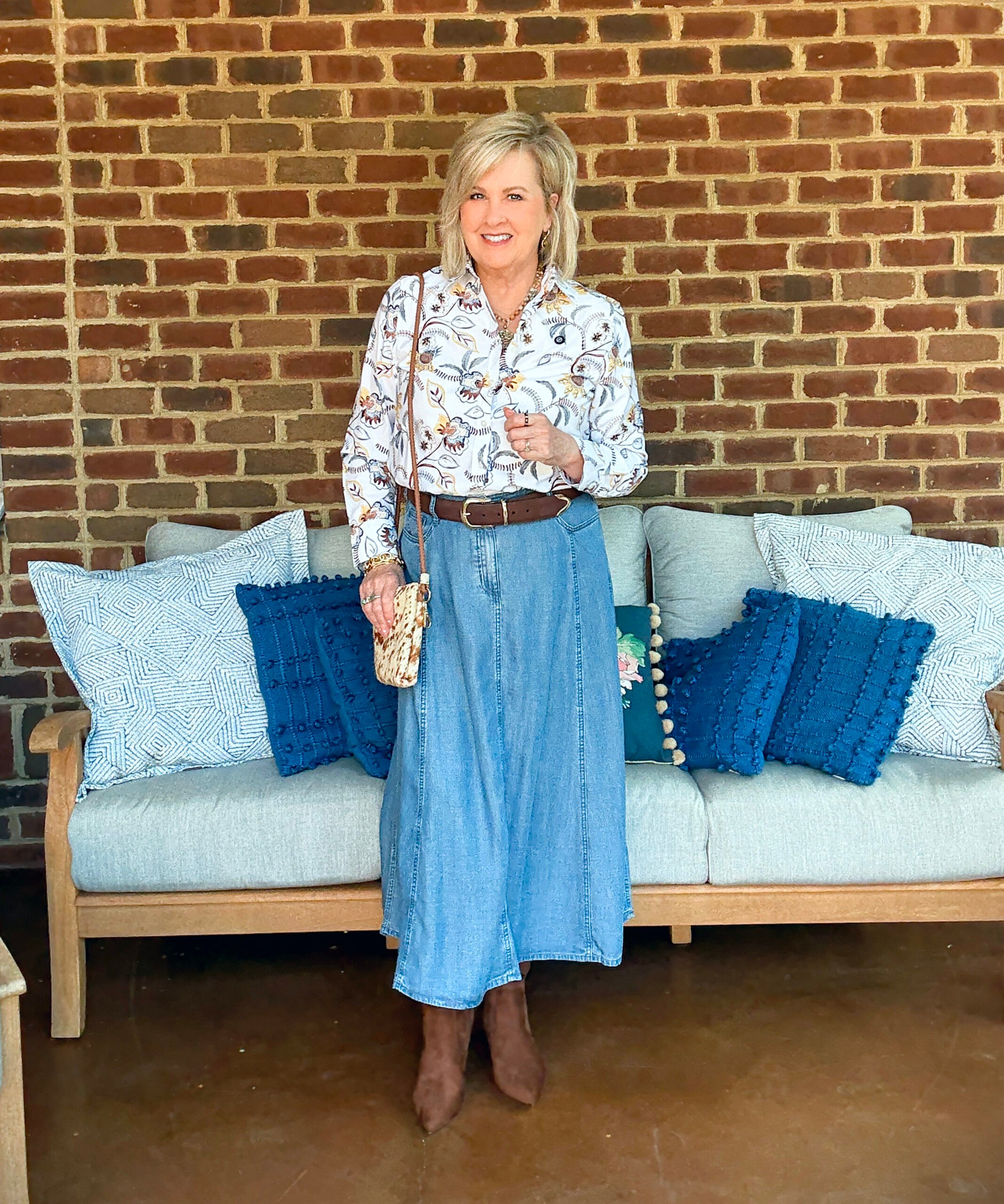 Tania Stephens showing a button up shirt with a denim skirt from Chico's and boots