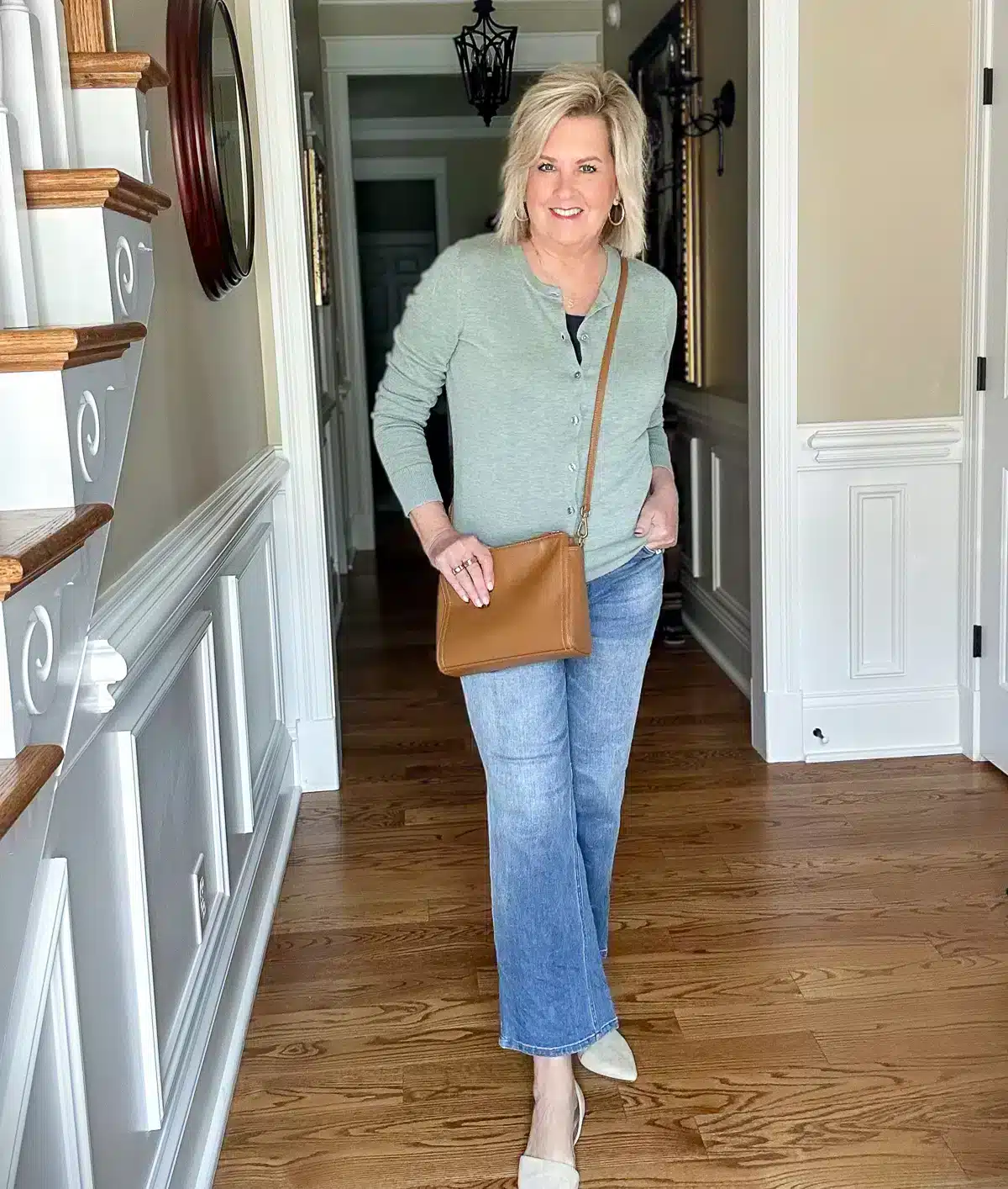 Tania Stephens wearing a green cardigan and cropped denim jeans