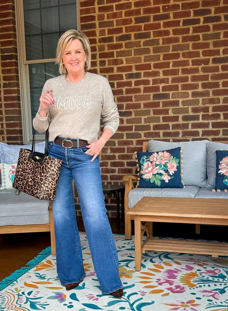 Tania Stephens is styling wide leg jeans and a AMOUR sweater from Tuckernuck