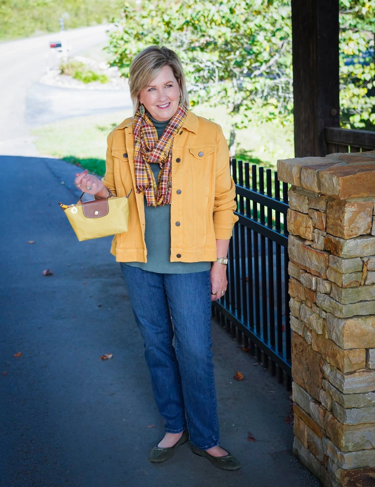 Tania Stephens i wearing a ribbed green top with a jeans and a plaid scarf during a Coldwater Creek Try On Haul for fall