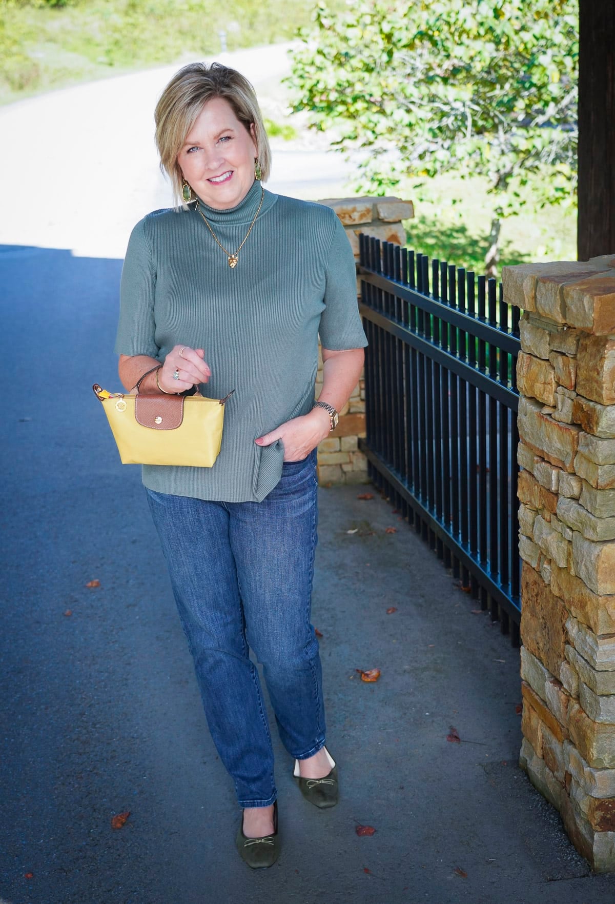 Tania Stephens i wearing a ribbed green top with a jeans during a Coldwater Creek Try On Haul for fall