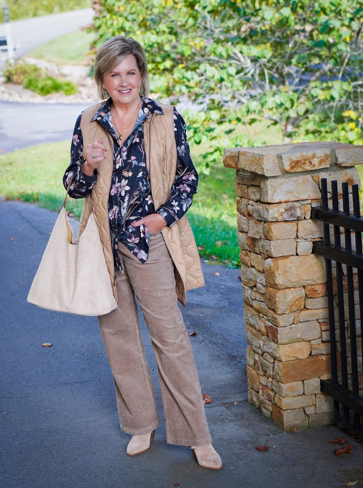 Tania Stephens i wearing a floral button up shirt and a long vest during a Coldwater Creek Try On Haul for fall