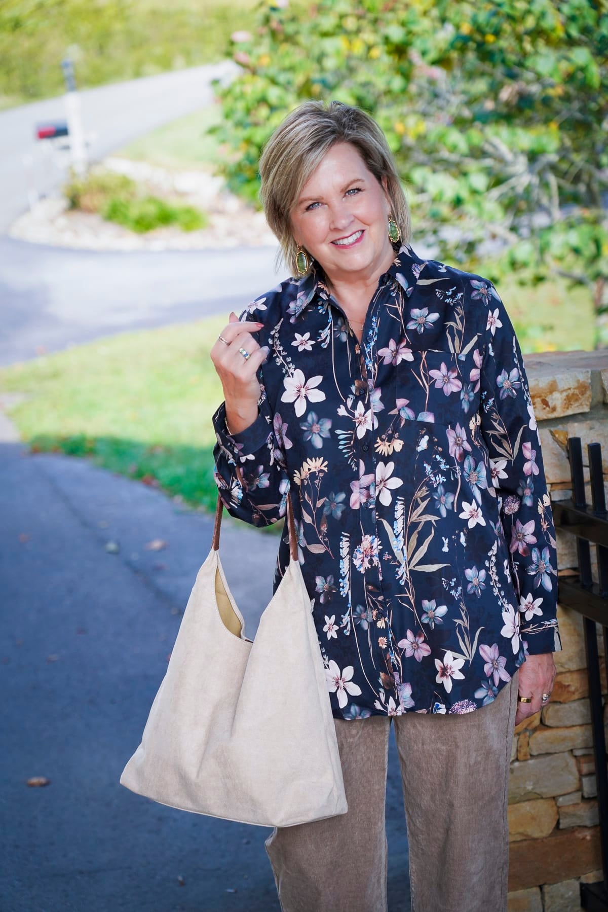 Tania Stephens i wearing a blue floral button up shirt