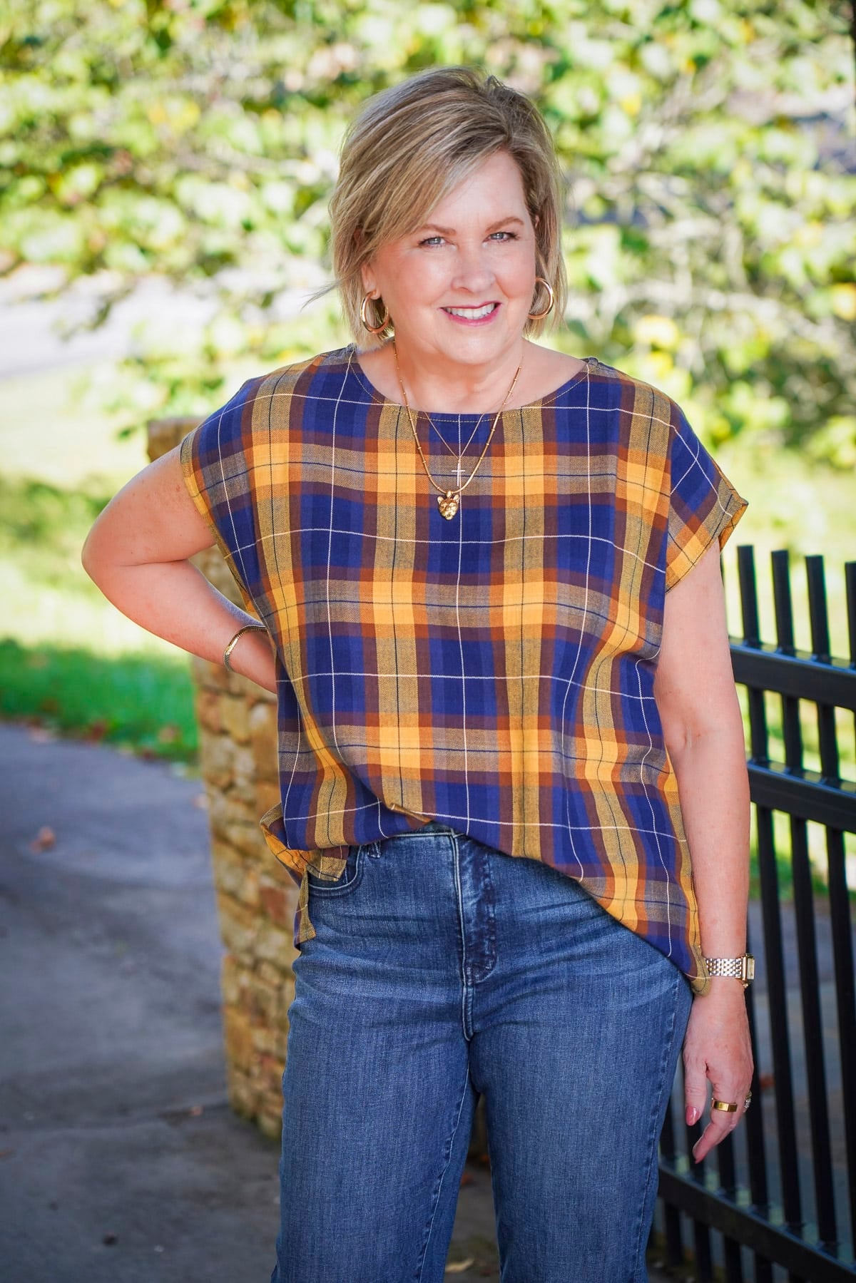 Tania Stephens i wearing a tucked blue and yellow check top during a Coldwater Creek Try On Haul