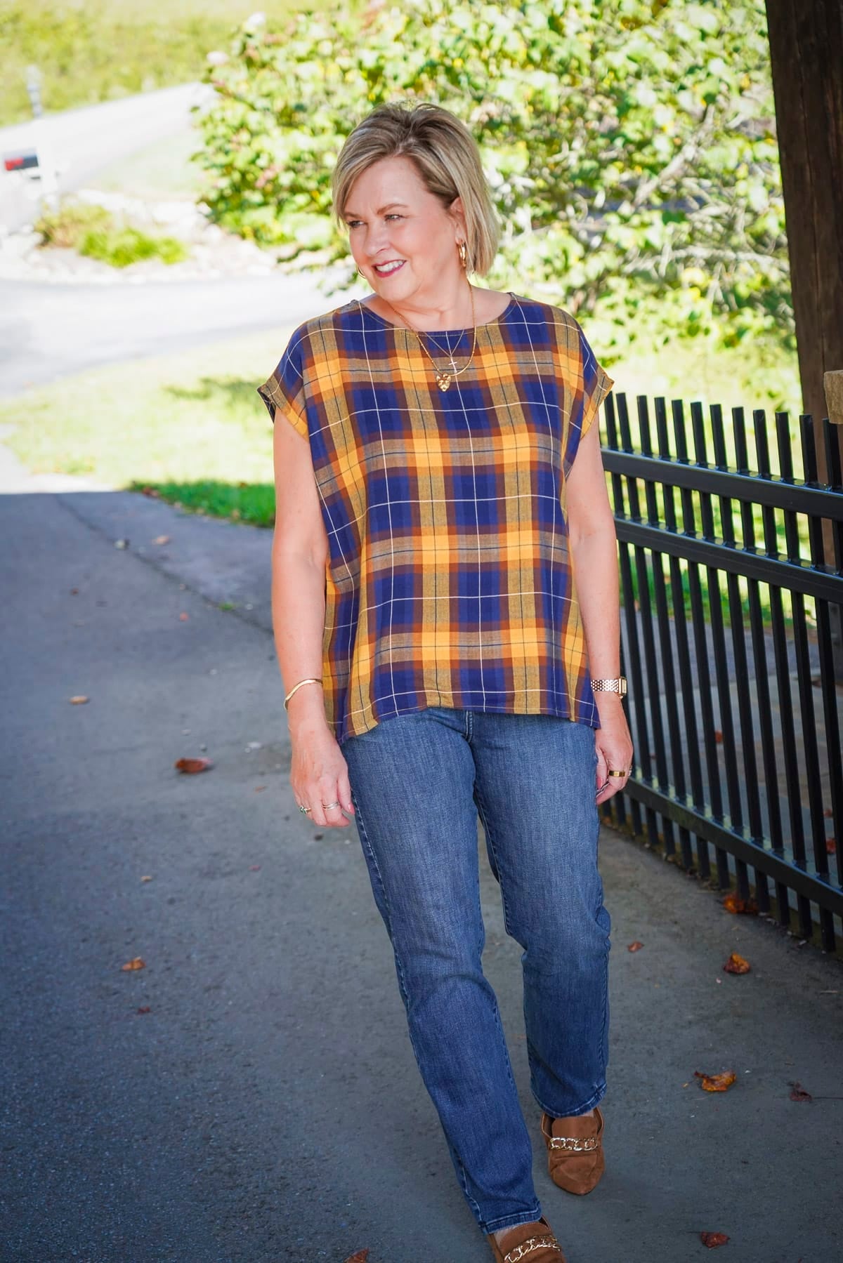 Tania Stephens i wearing a blue and yellow check top with jeans during a Coldwater Creek Try On Haul for 2024