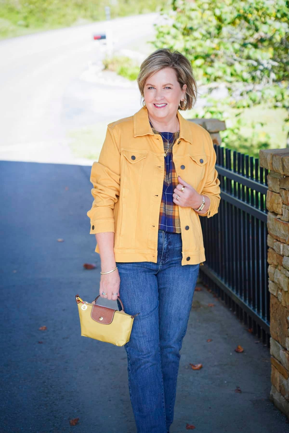 Tania Stephens i wearing a blue and yellow top with a yellow denim jacket during a Coldwater Creek Try On Haul for fall