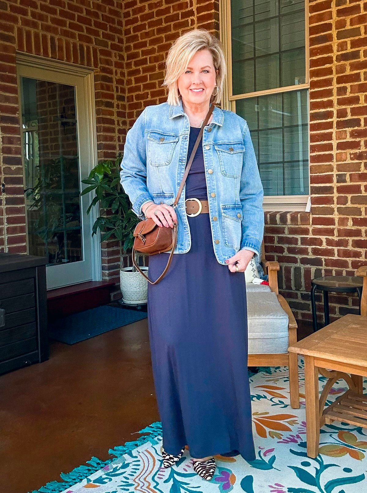 Tania Stephens is wearing a denim jacket and a navy maxi dress