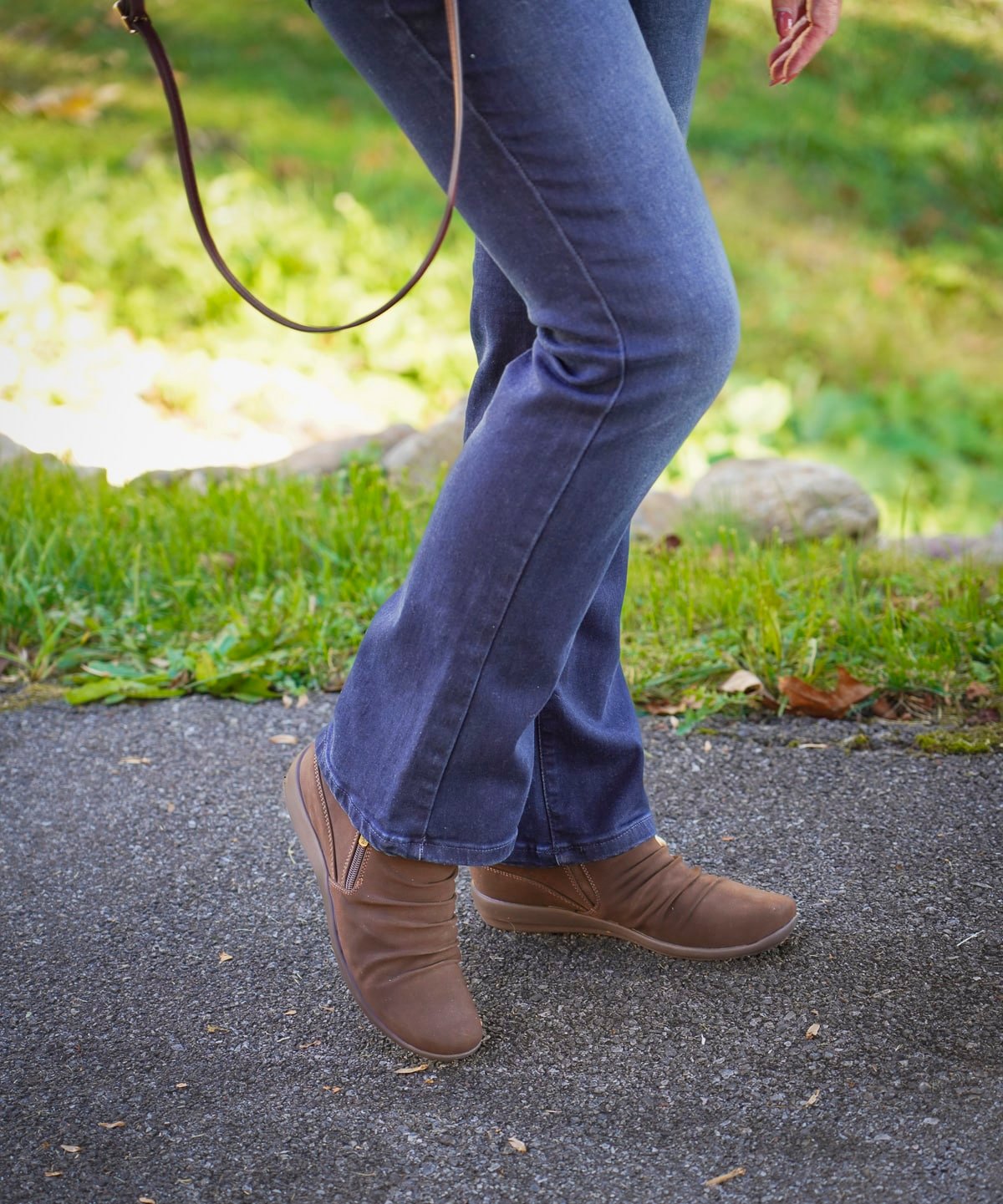 Tania Stephens is wearing a cowl neck sweater, jeans, and brown Easy Spirit boots for Thanksgiving