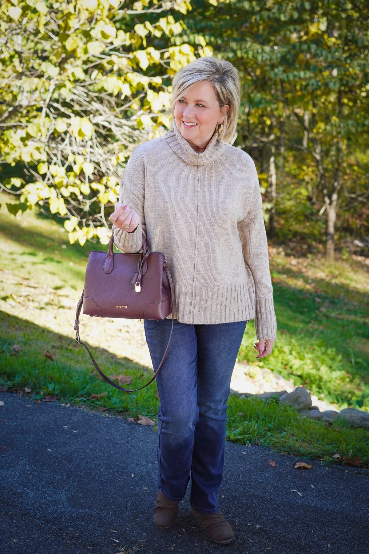 Tania Stephens is wearing a cowl neck sweater with jeans for Thanksgiving