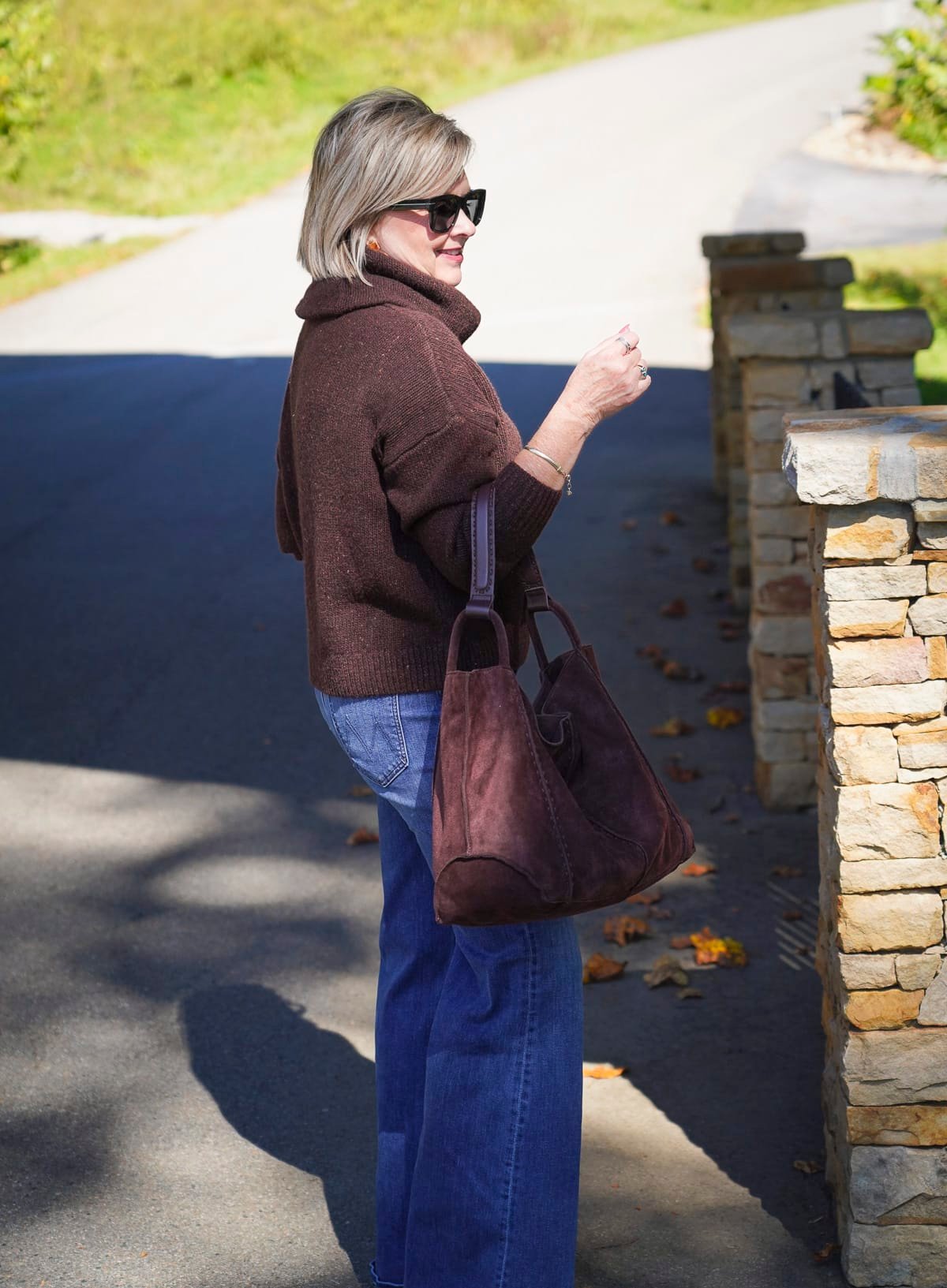 Tania Stephens is styling Trending Chocolate Brown This Fall with a brown turtleneck sweater with a brown suede tote