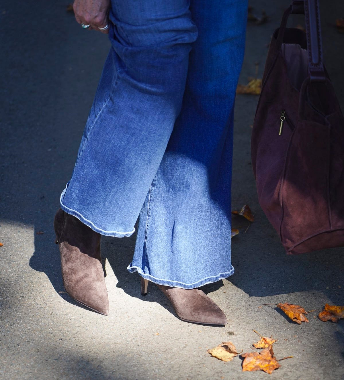 Tania Stephens wearing wide leg jeans and brown pointy toe boots