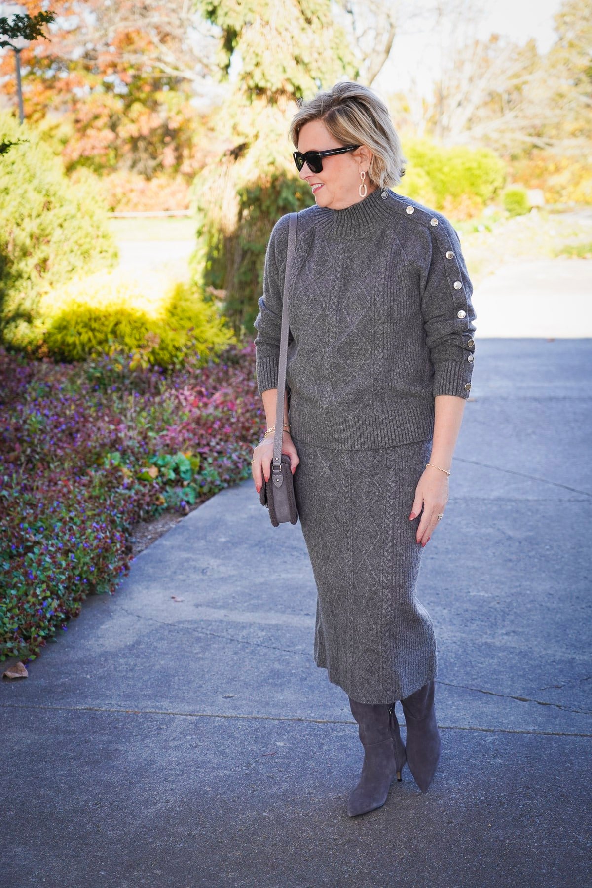 Tania Stephens is wearing a gray cable knit sweater set for the holidays