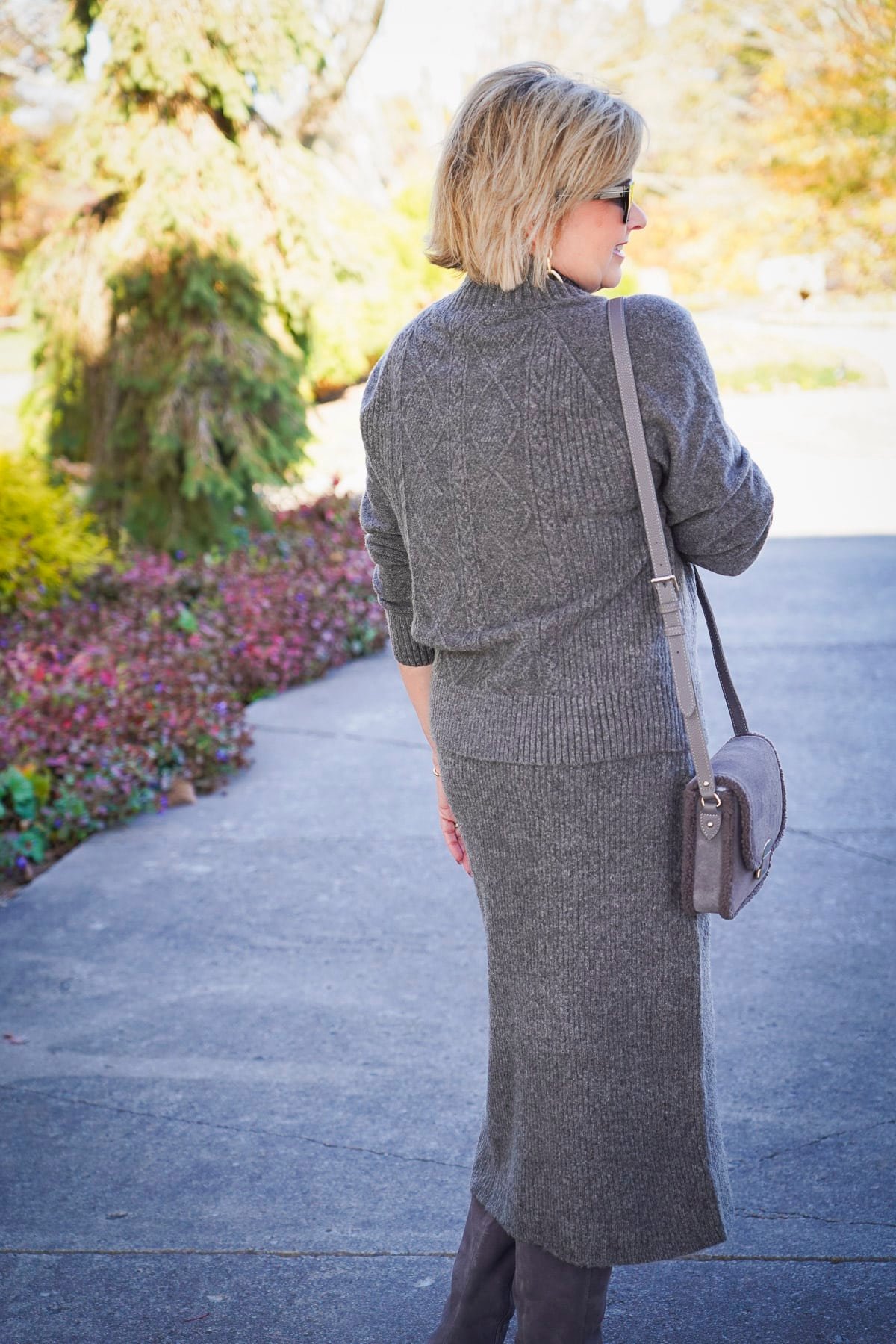 Tania Stephens is showing the back of a gray cable knit sweater set for the holidays