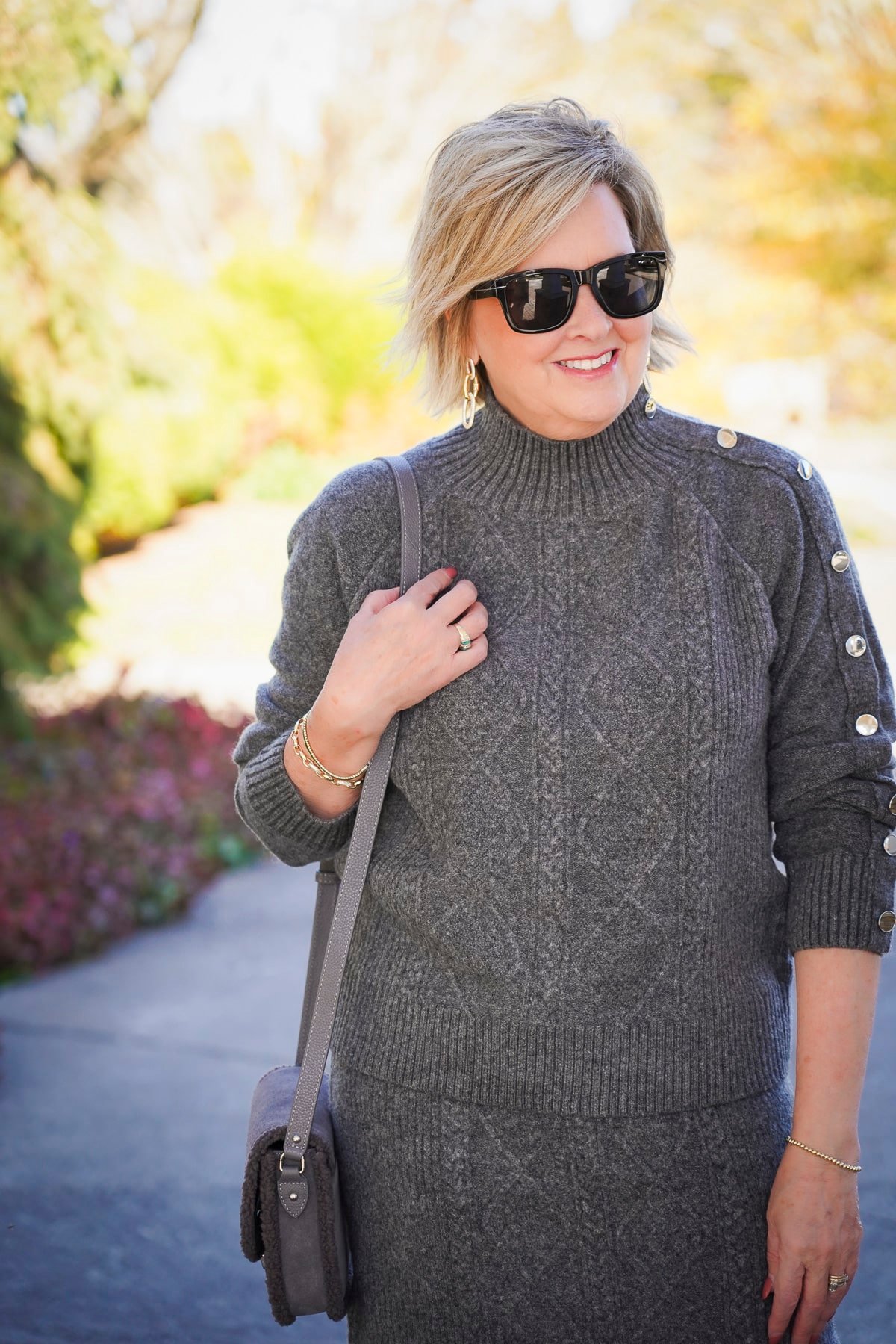 Tania Stephens is wearing a gray cable knit sweater for the holidays
