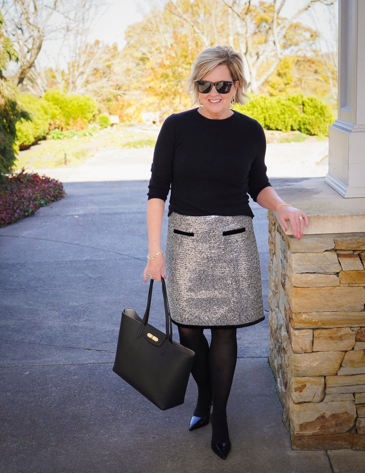 Tania Stephens is wearing a black cashmere sweater and a trimmed sequin skirt for the holidays