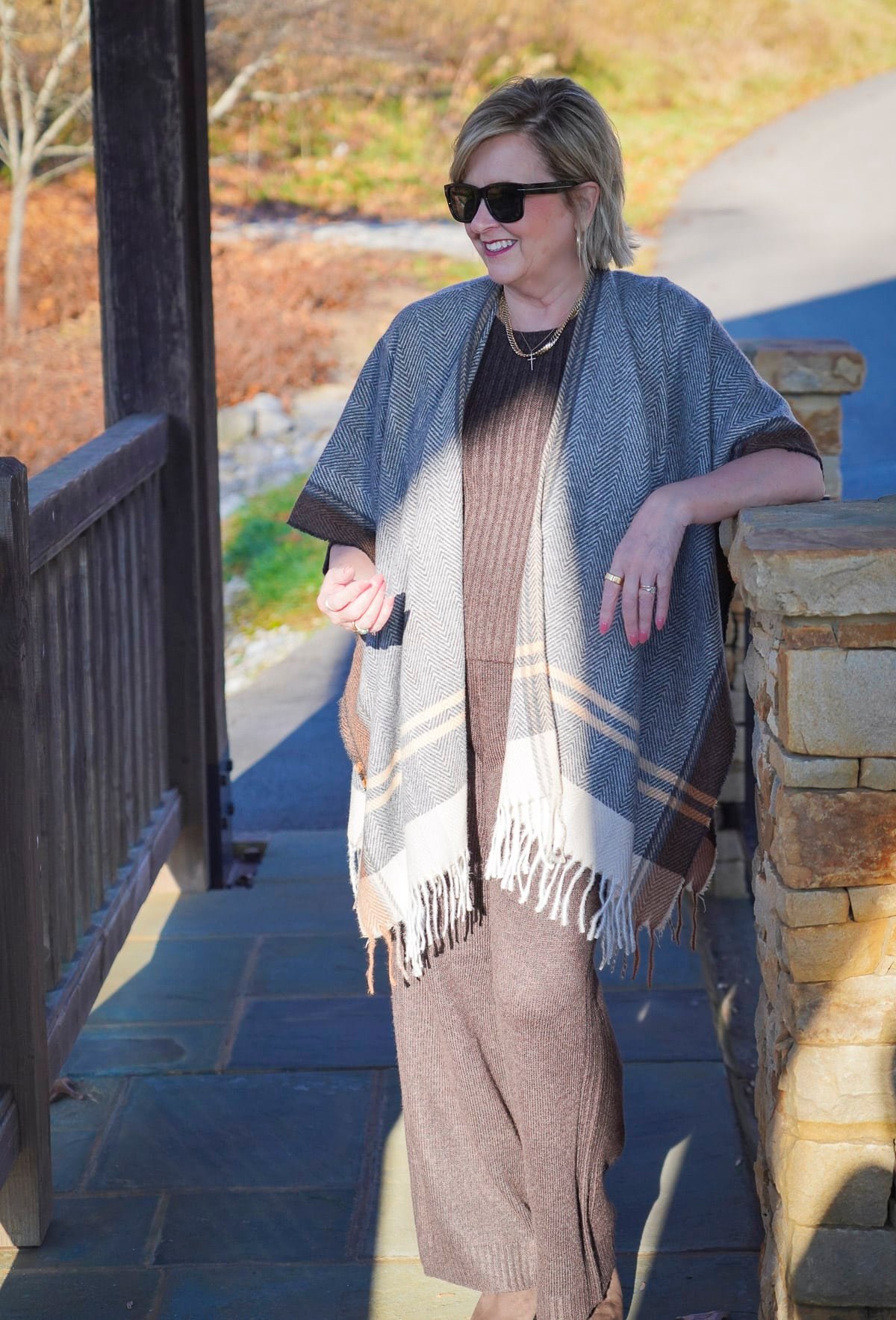 Tania Stephens wearing a dark brown sweater tank and a striped Ruana