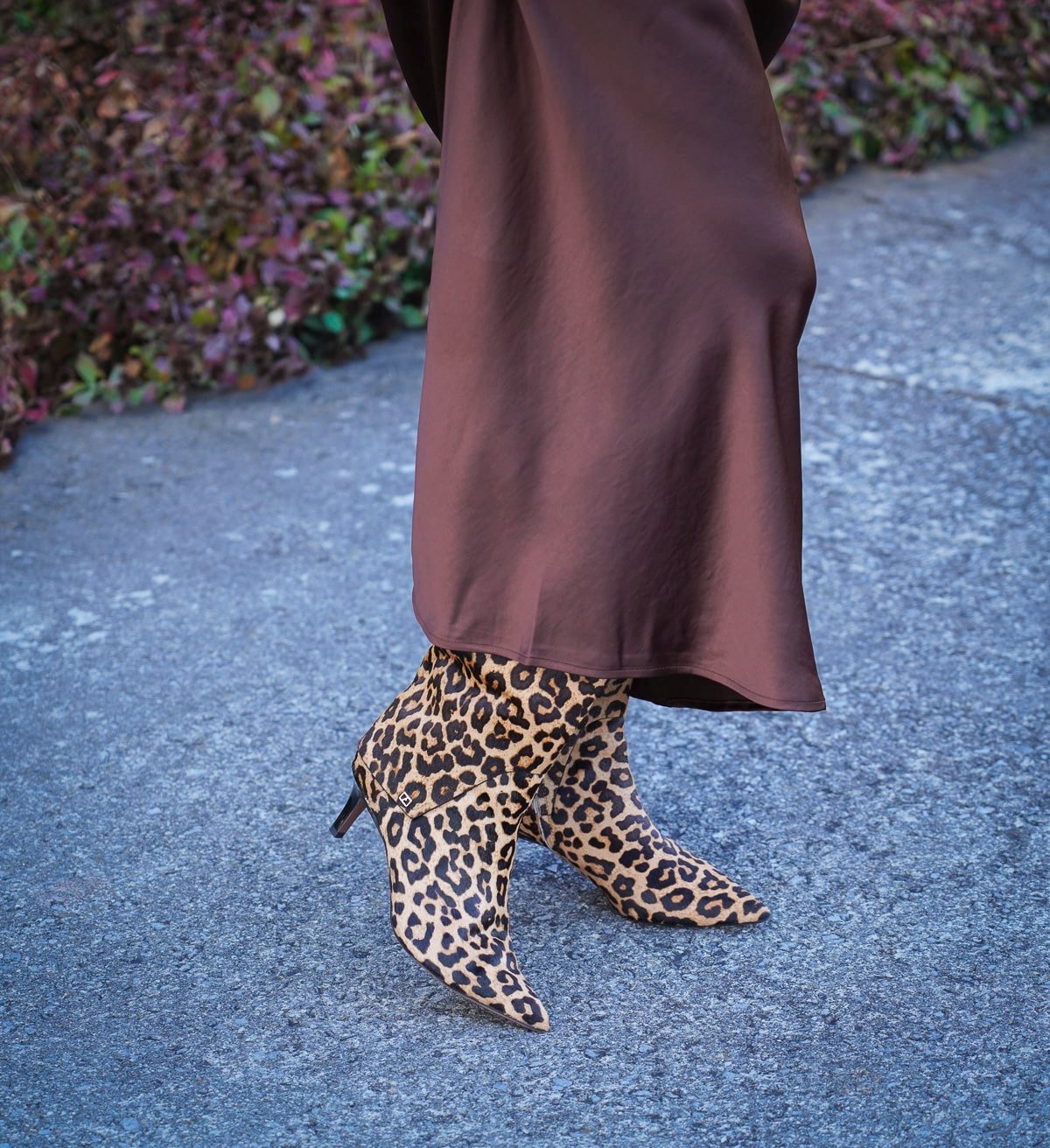 Tania Stephens is wearing a brown satin slip with leopard print boots
