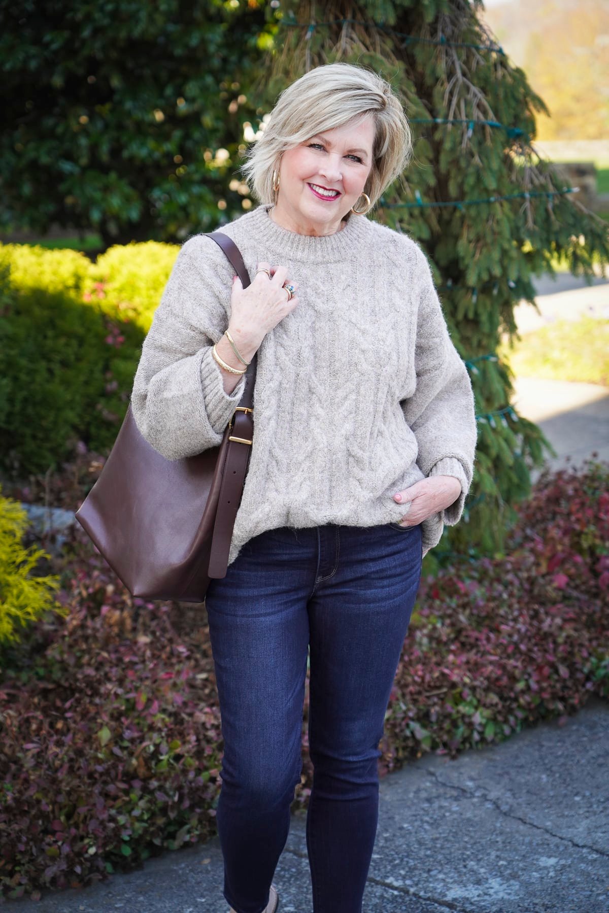 Tania Stephens is wearing an oversized sweater and skinny jeans from Nordstrom