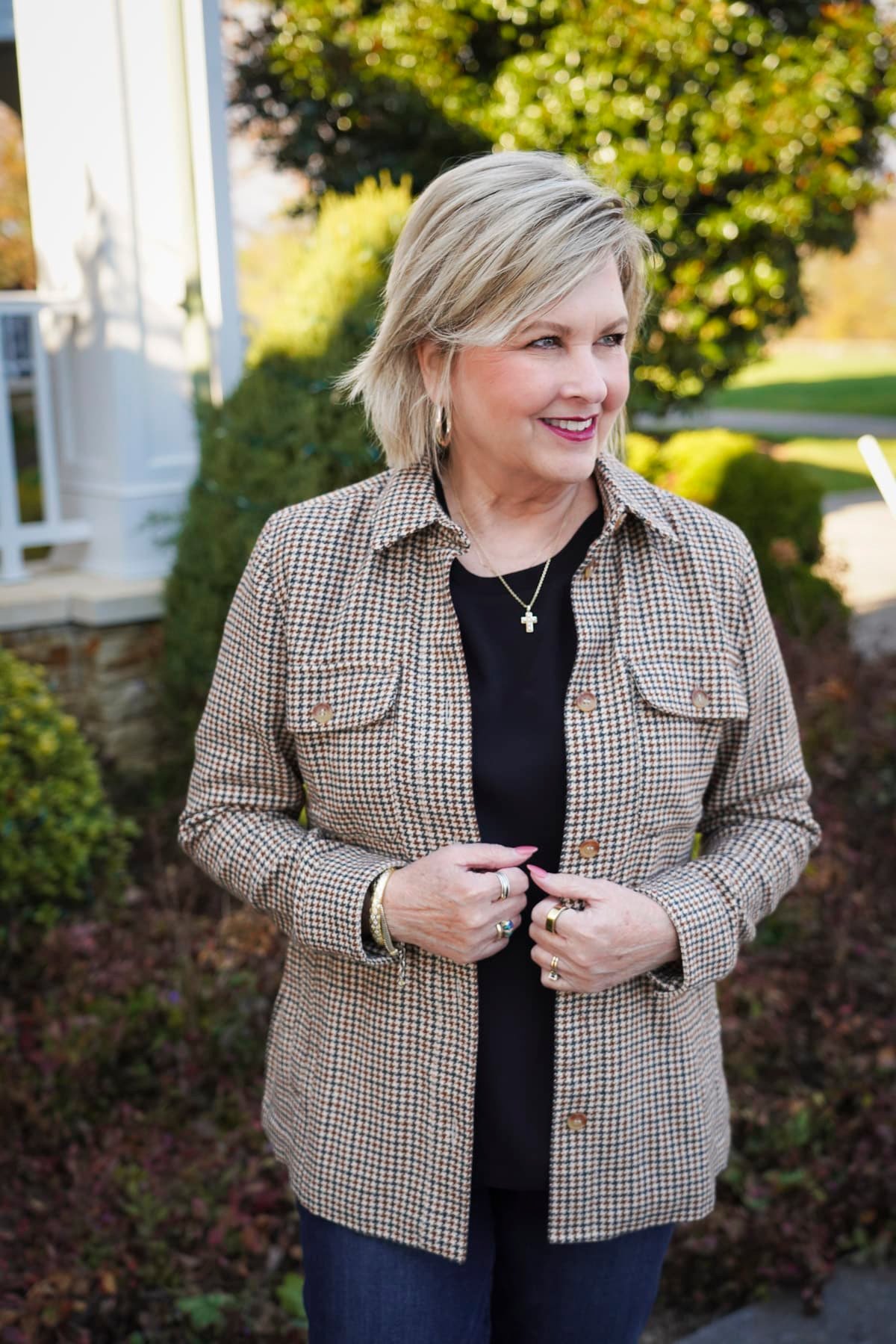 Tania Stephens is wearing a black tee, and a plaid jacket