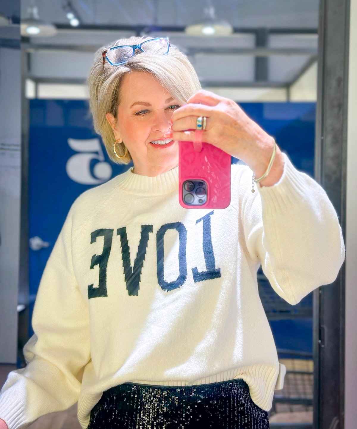 Tania is wearing a white LOVE sweater