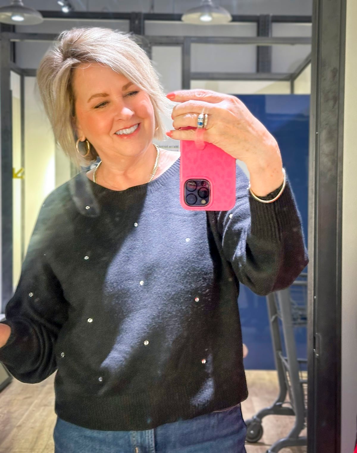 Tania Stephens wearing a black sweater with rhinestones