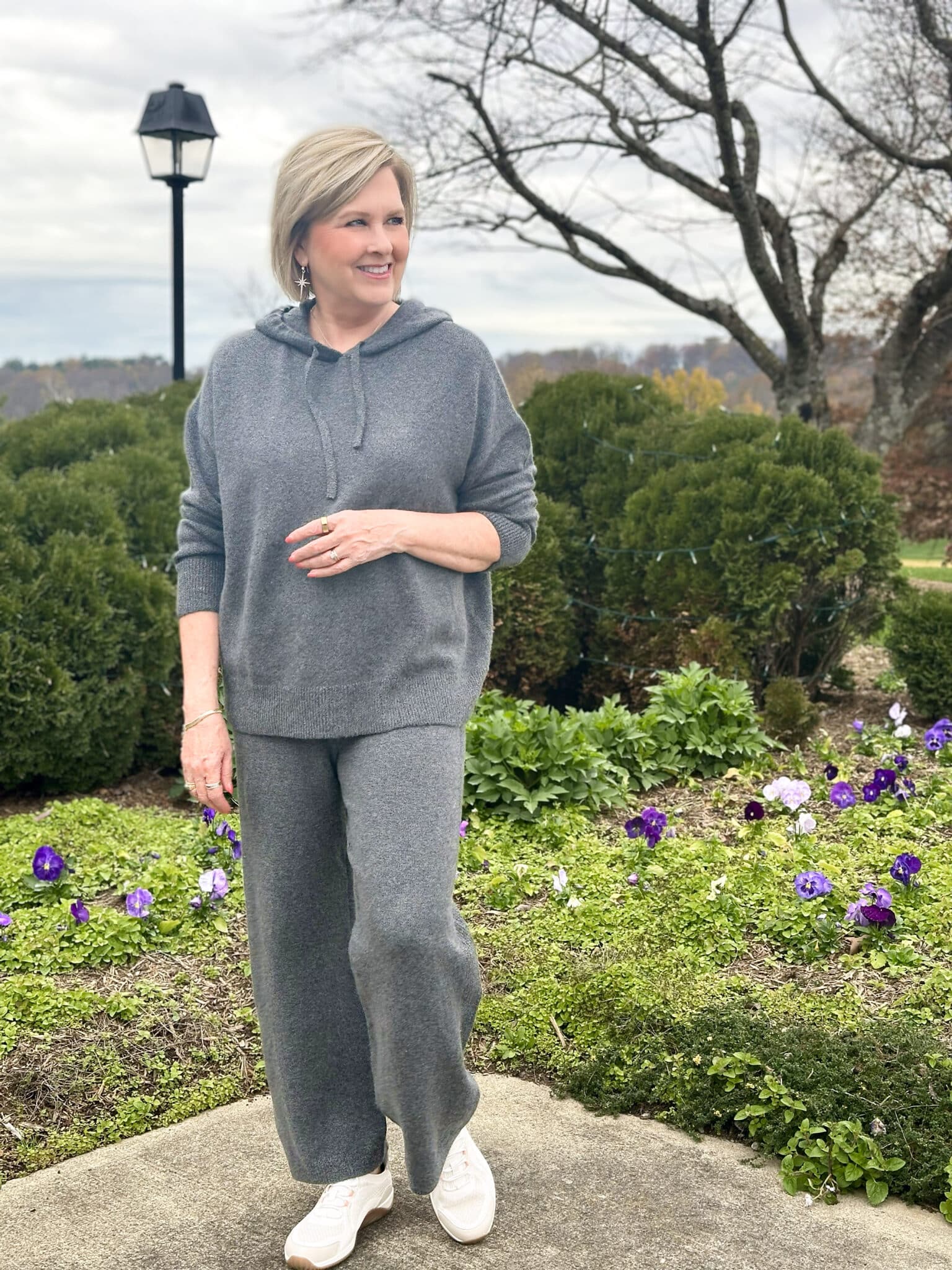 Tania Stephens is wearing a charcoal gray hoodie sweater and matching sweater pants