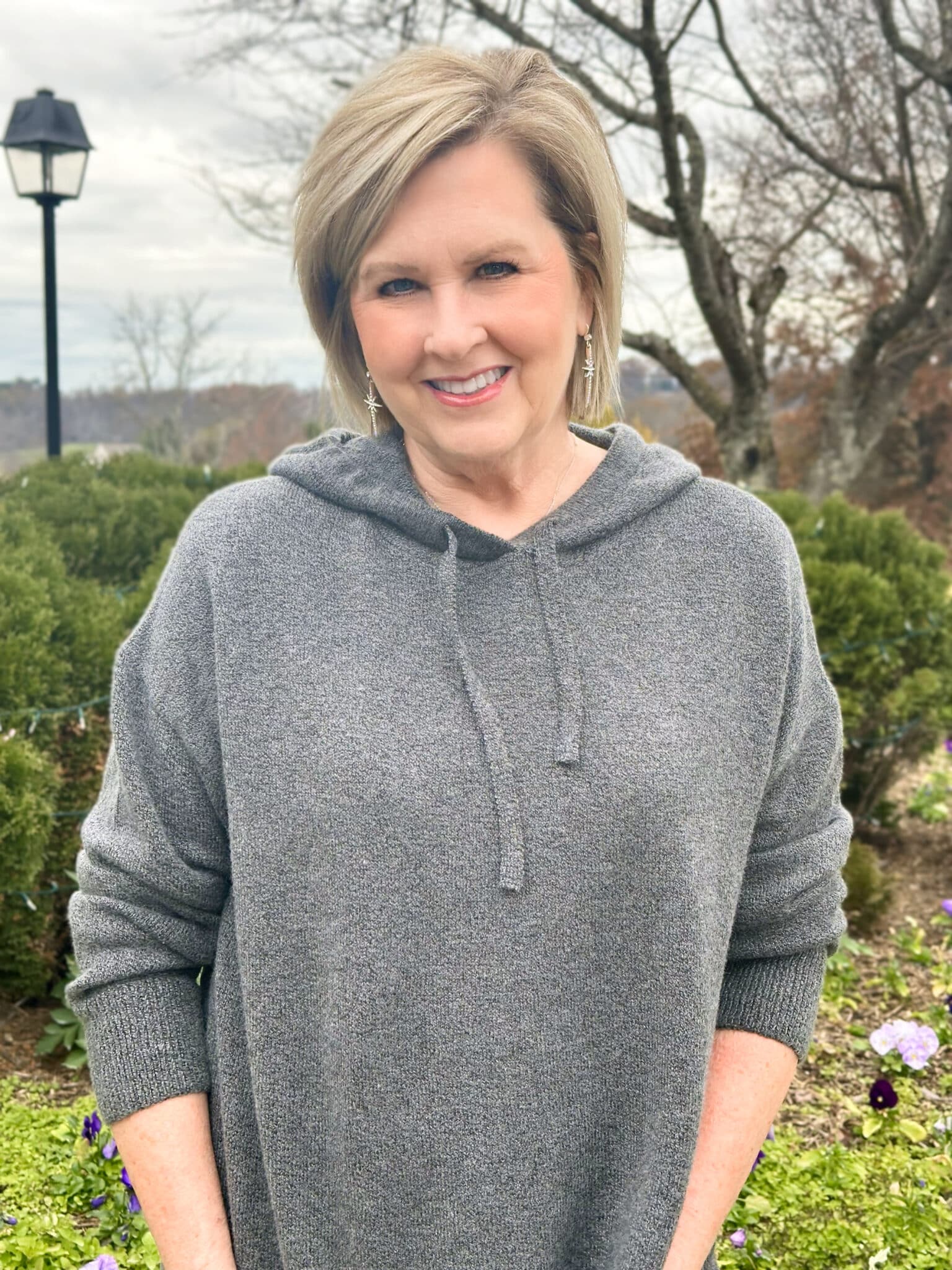 Tania Stephens is wearing a charcoal gray hoodie sweater 