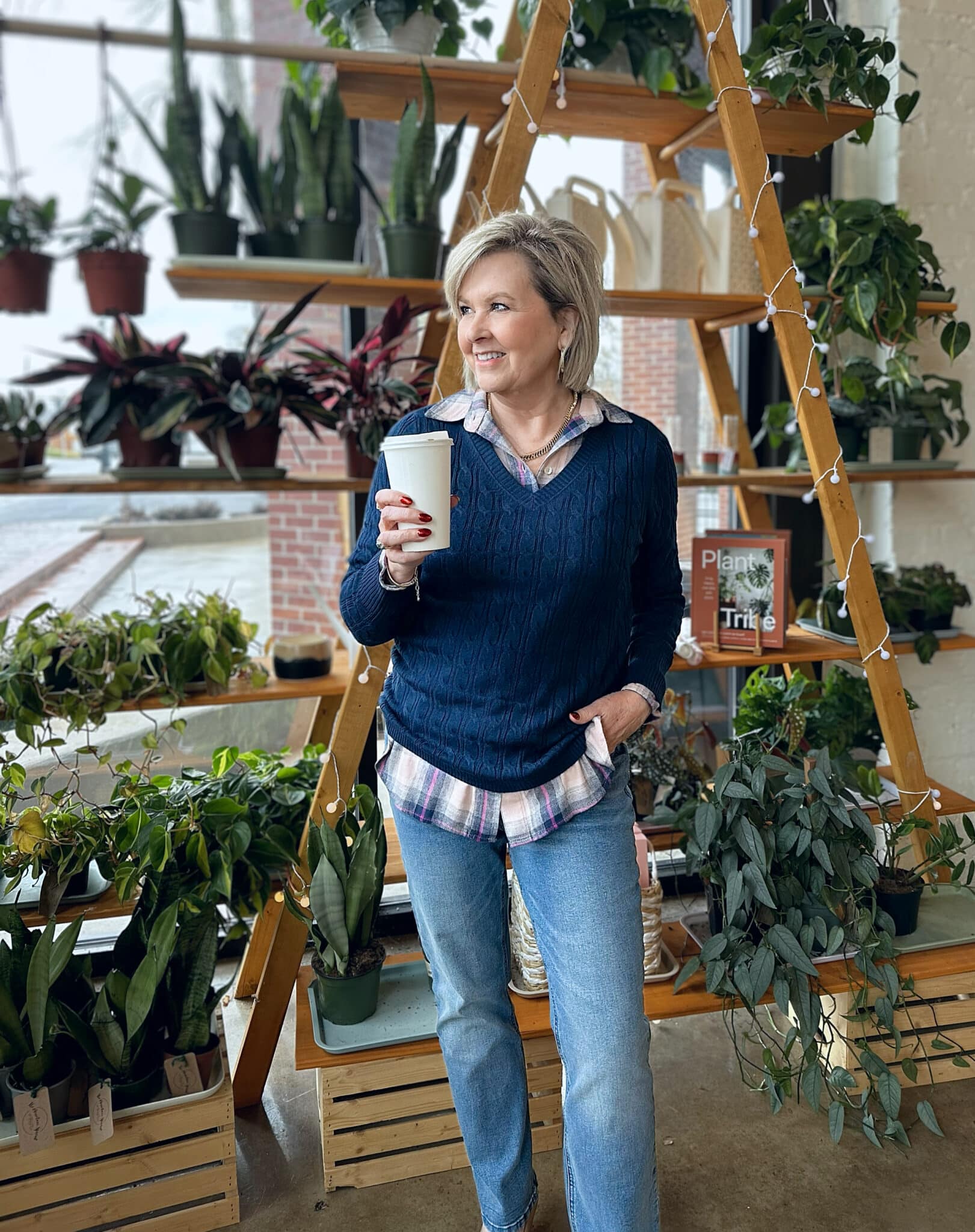Tania Stephens is wearing a plaid shirt under a navy sweater and straight leg jeans from Kohl's