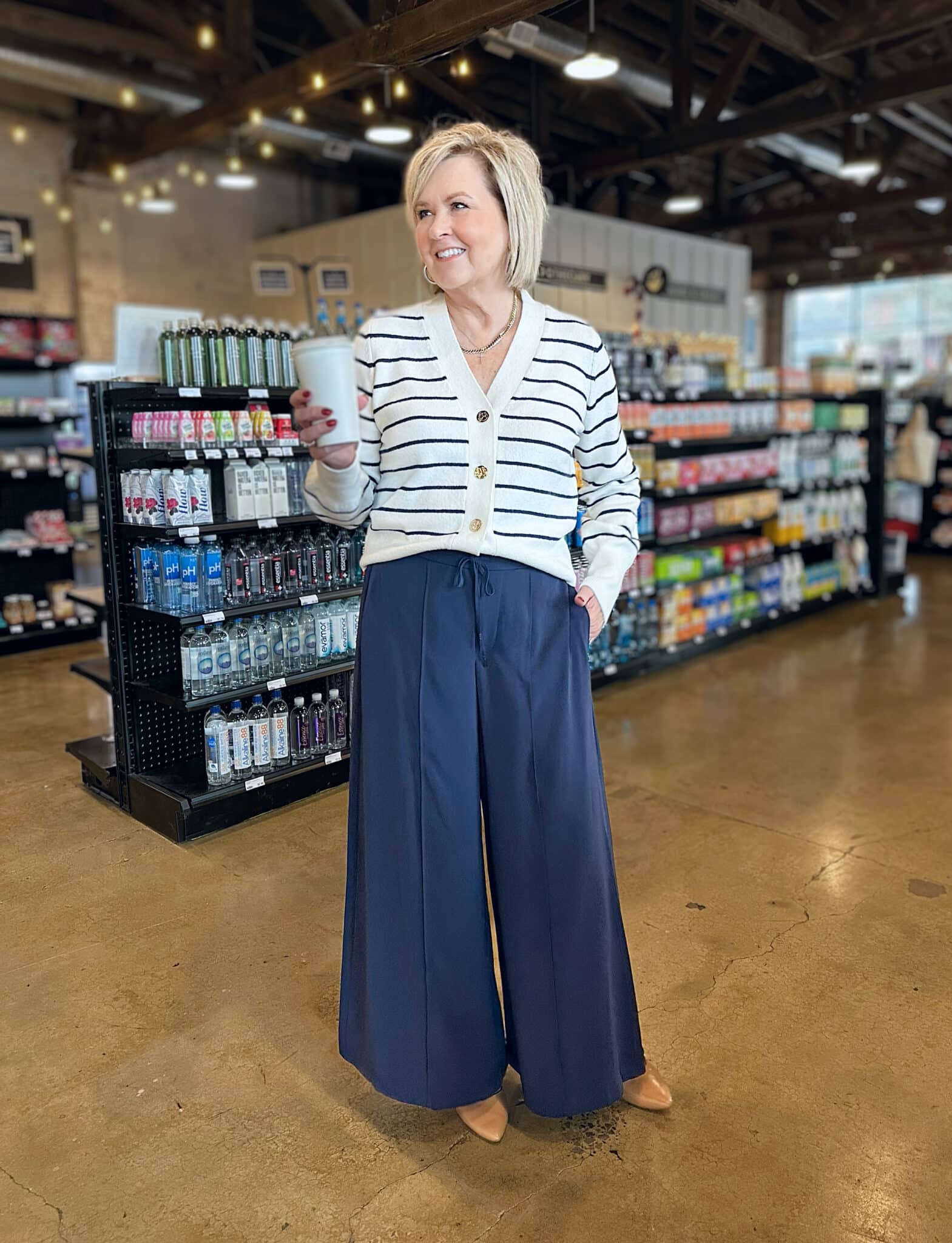 Tania Stephens is wearing a striped sweater and navy palazzo pants from Kohl's