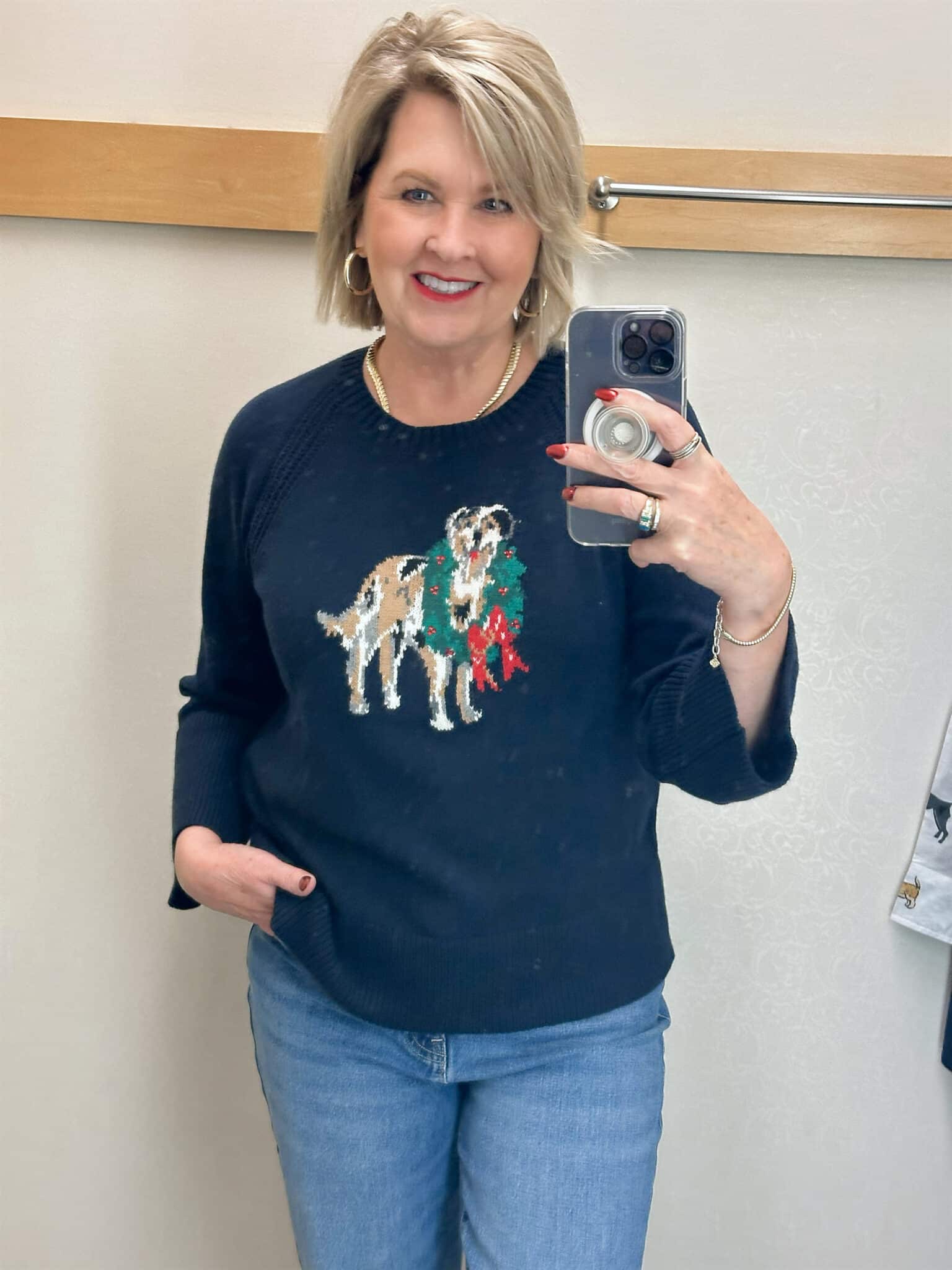 Tania Stephens is wearing a navy sweater with a dog